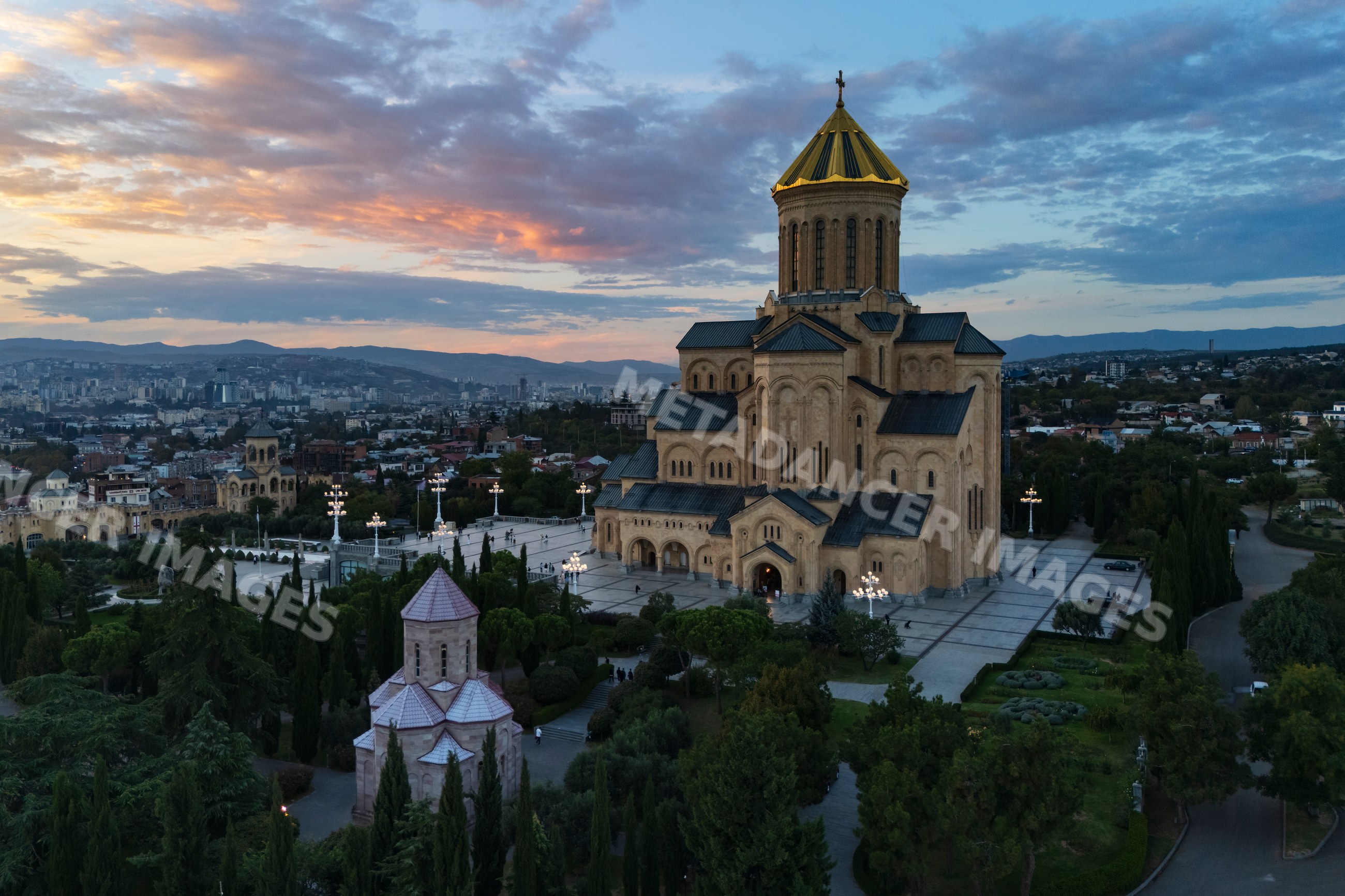 Holy trinity cathedral of Tbilisi at Sunset with city skyline