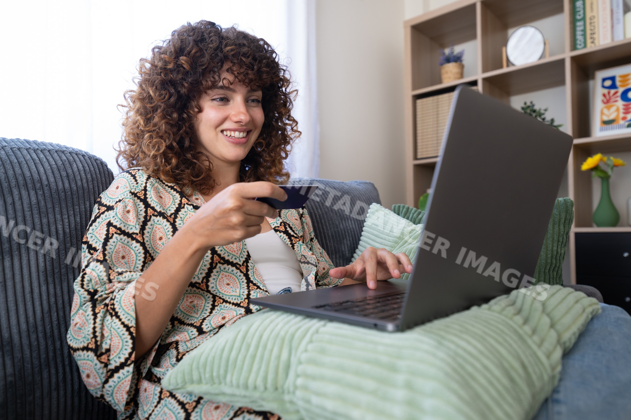 White woman shopping online on laptop holding credit card