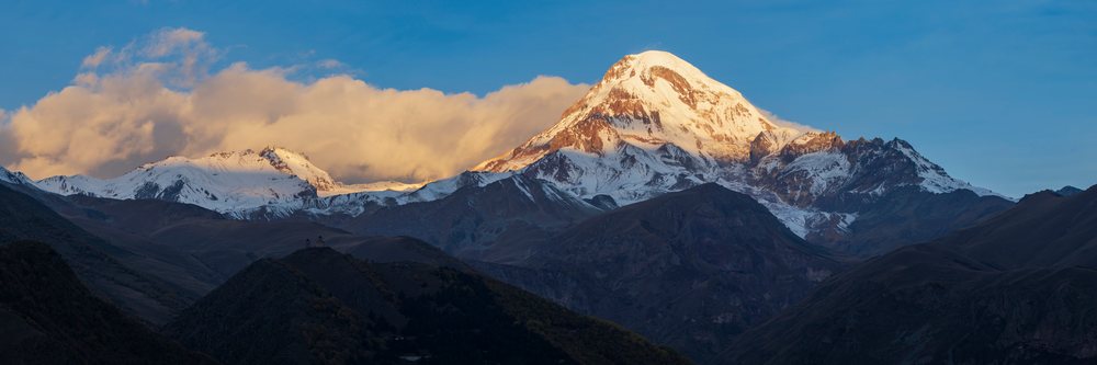 Mt kazbegi snow-capped peak at Sunrise in stepantsminda, Georgia