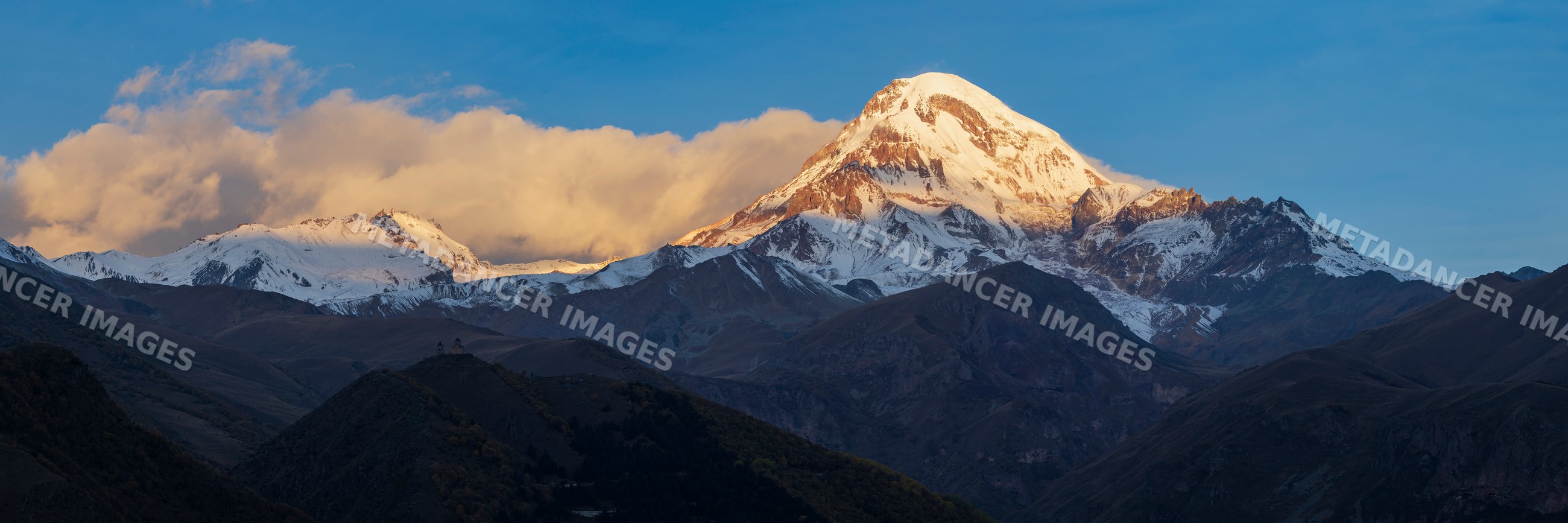 Mt kazbegi snow-capped peak at Sunrise in stepantsminda, Georgia