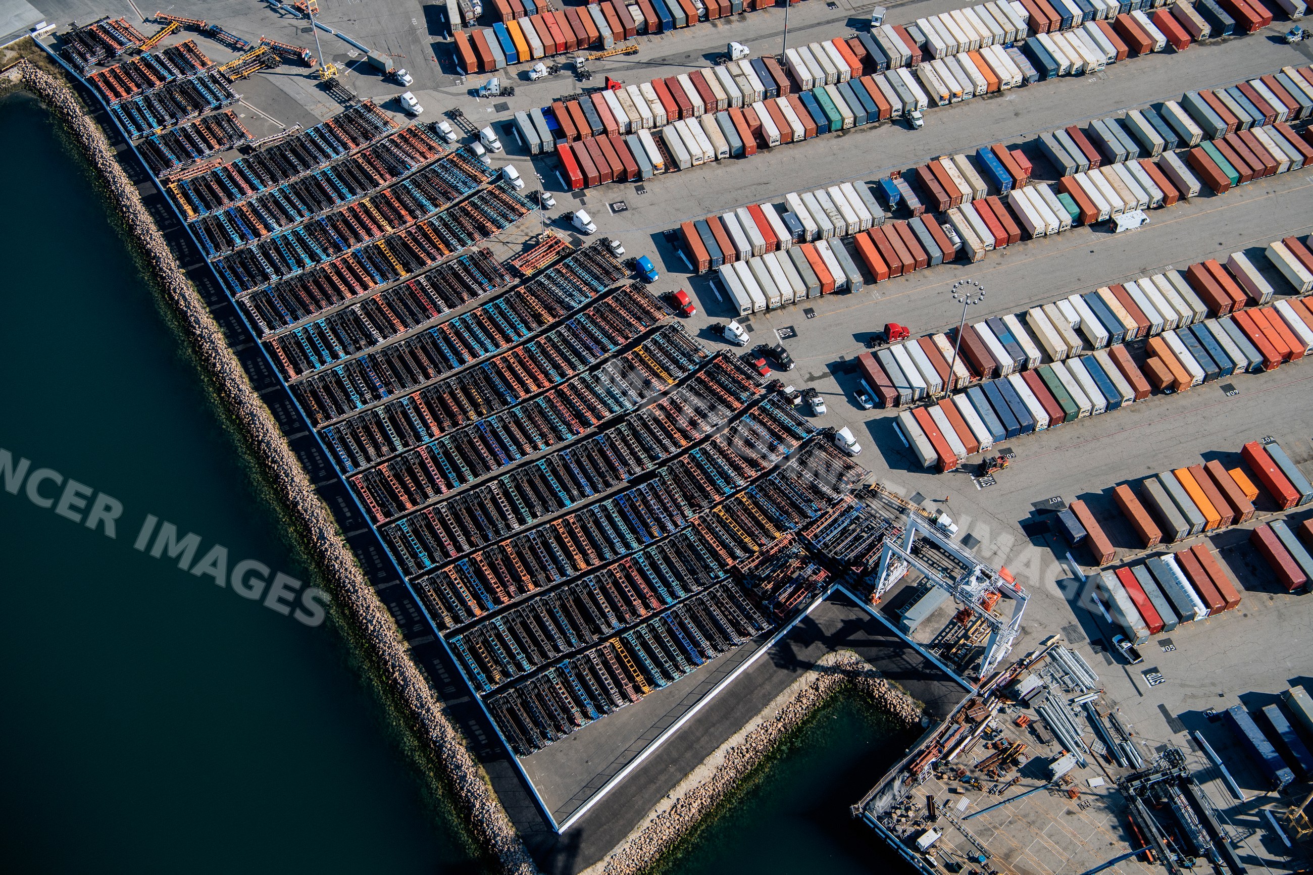 Container yard with trucks and cranes at a major port in long beach