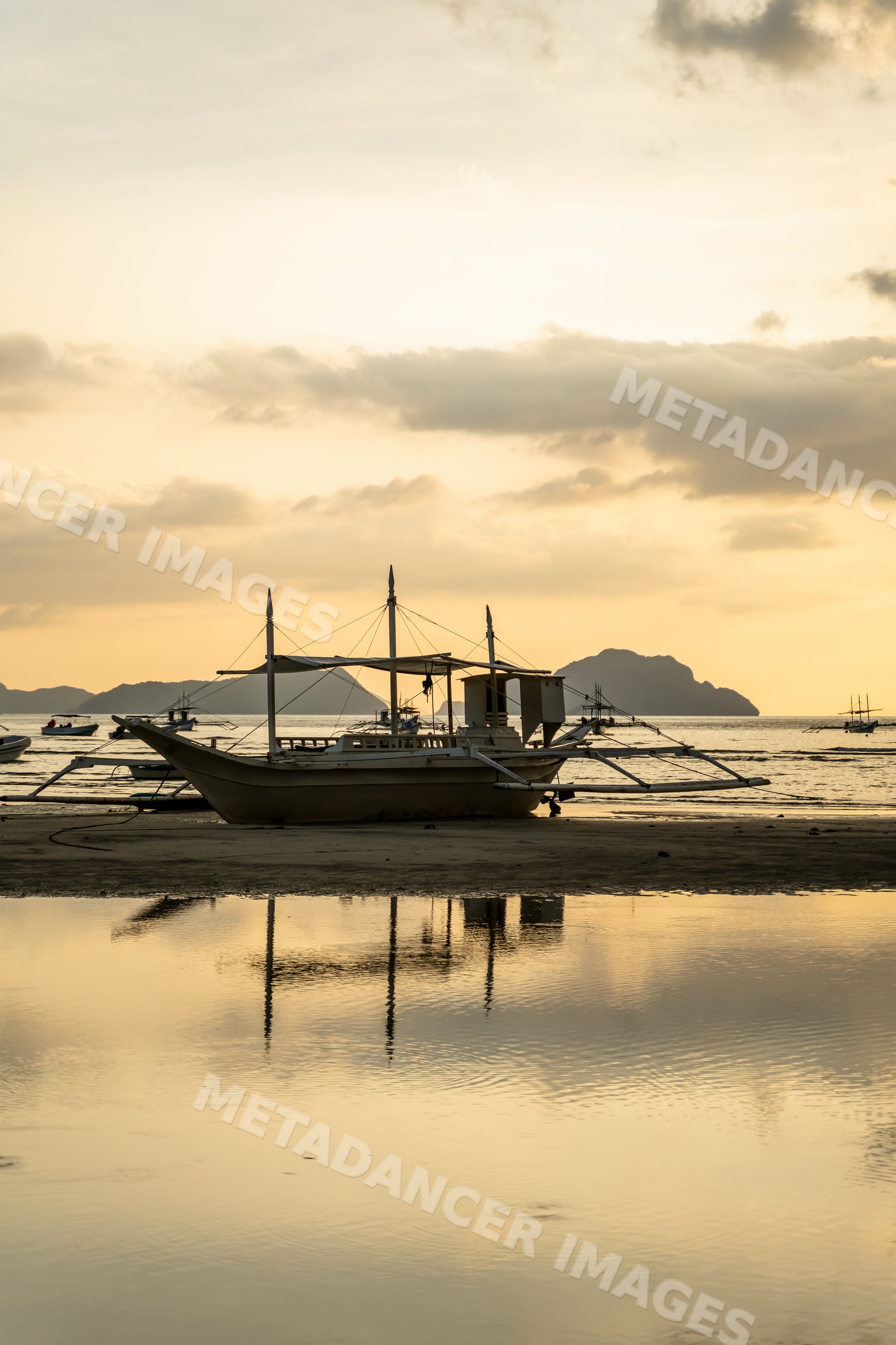 Fishing boat with outrigger on beach