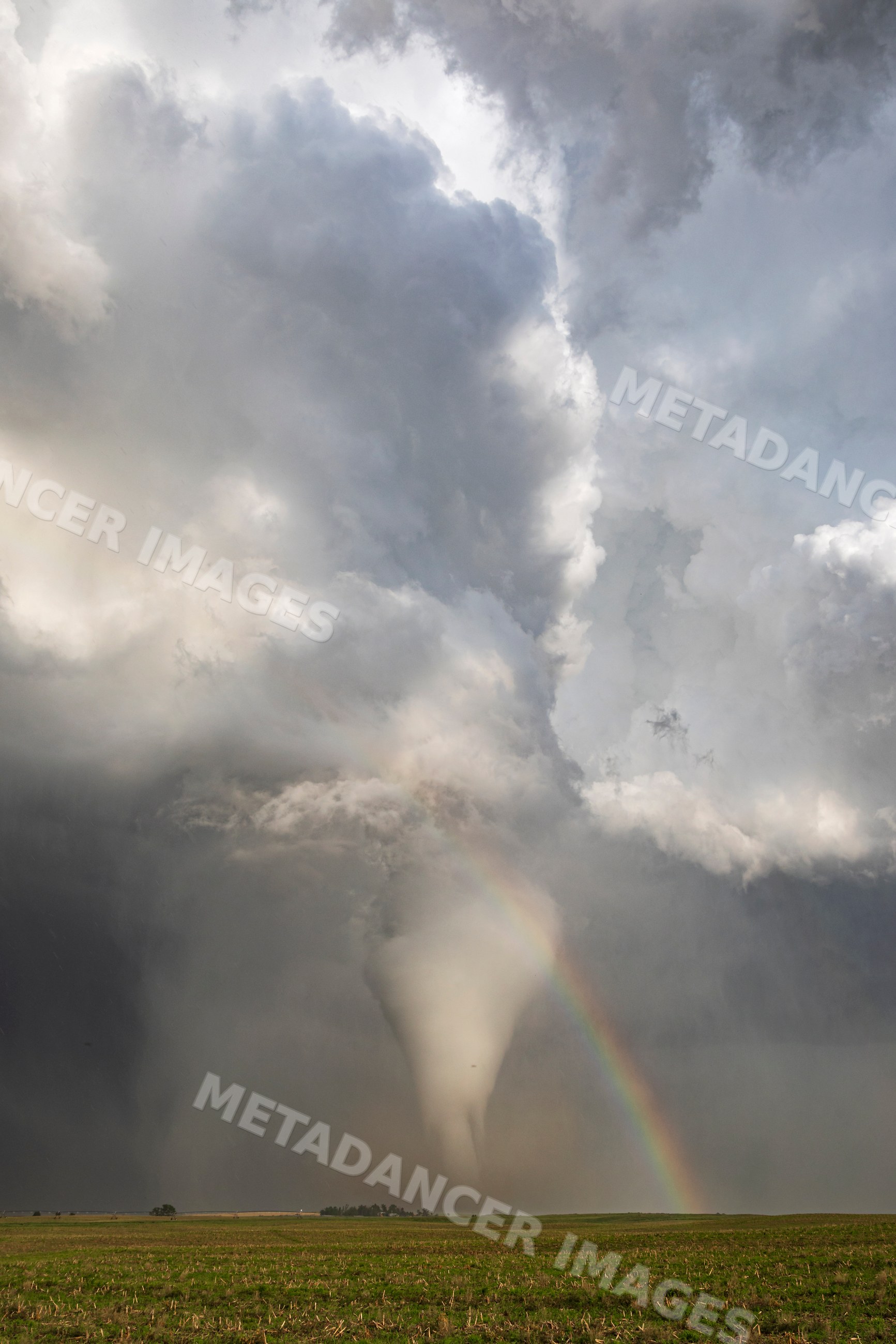Tornado with Rainbow over field in dickens nebraska
