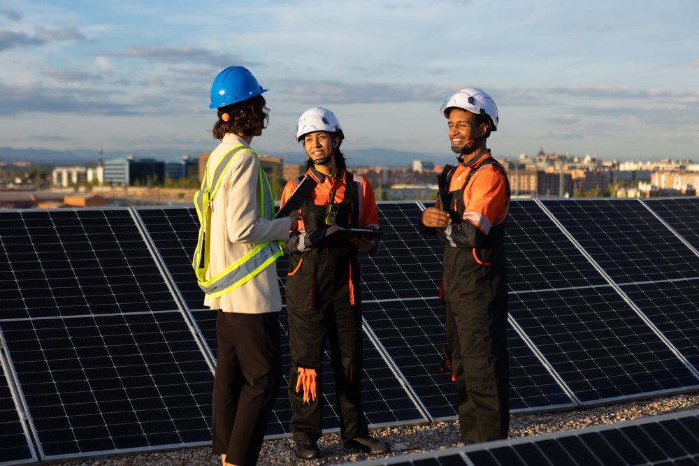 Engineers discussing solar panel installation on a rooftop in Madrid