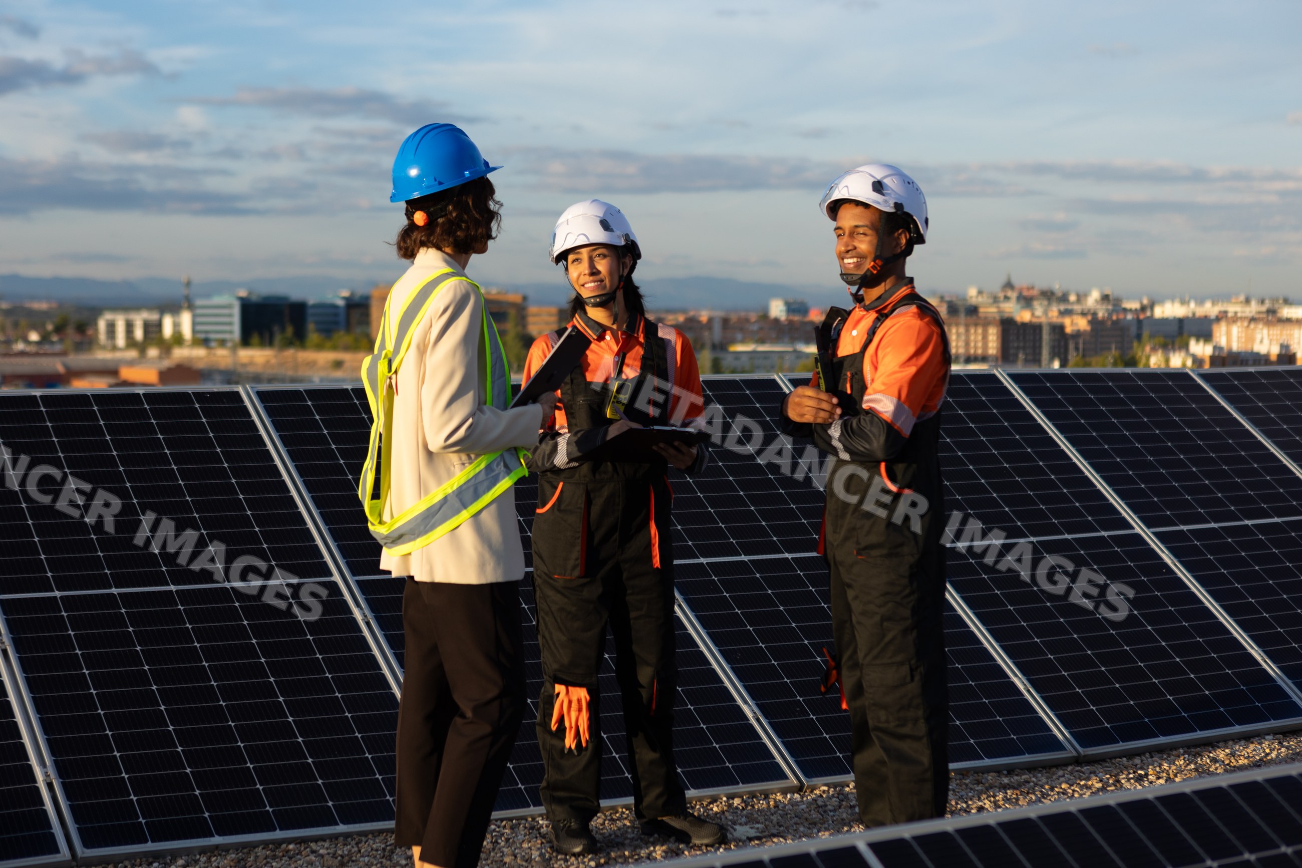 Engineers discussing solar panel installation on a rooftop in Madrid