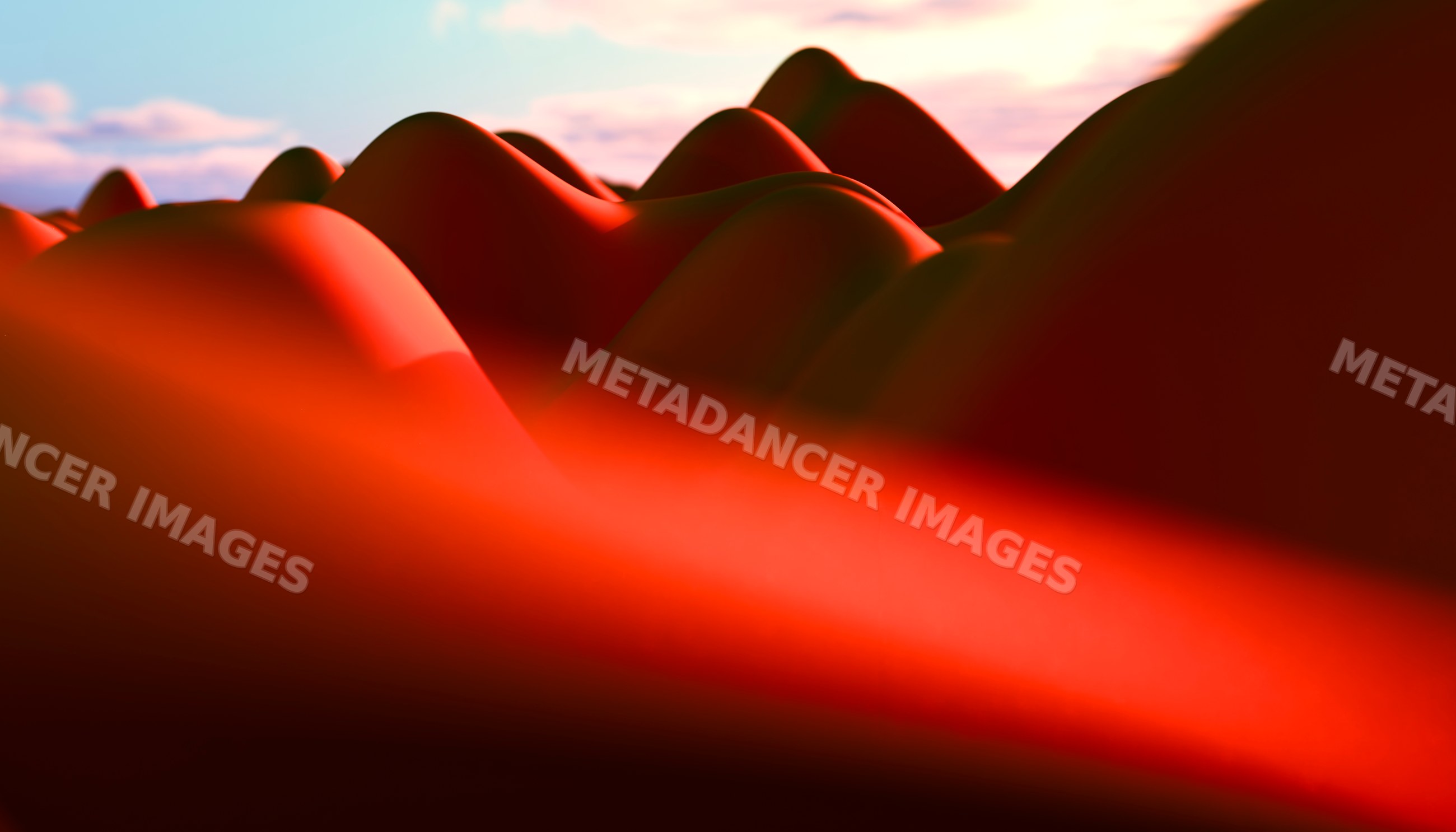 Smooth curved hills illuminated by warm red light at sunset