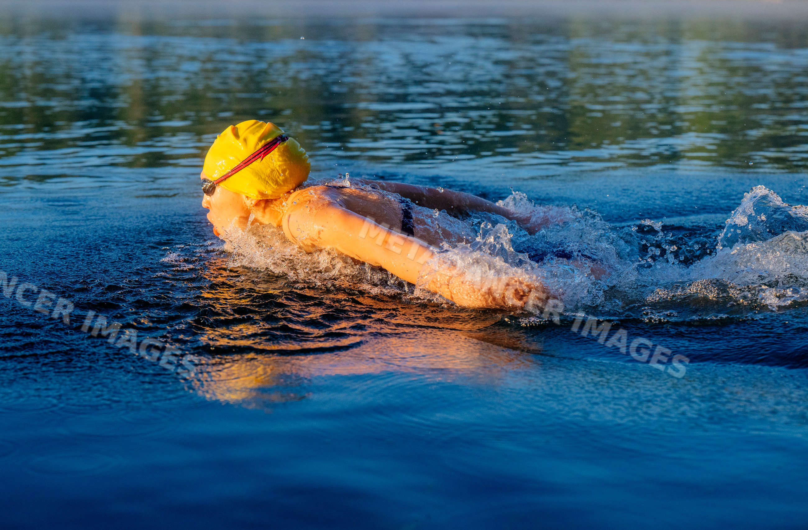 White swimmer performing freestyle stroke in open water