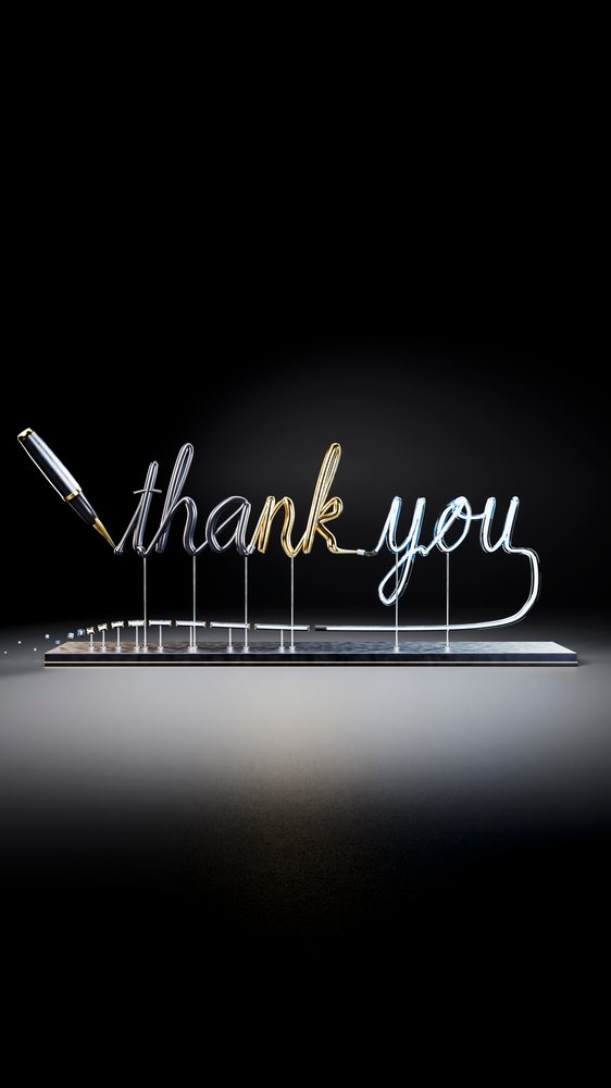 Metallic thank you text written with fountain pen on metal base