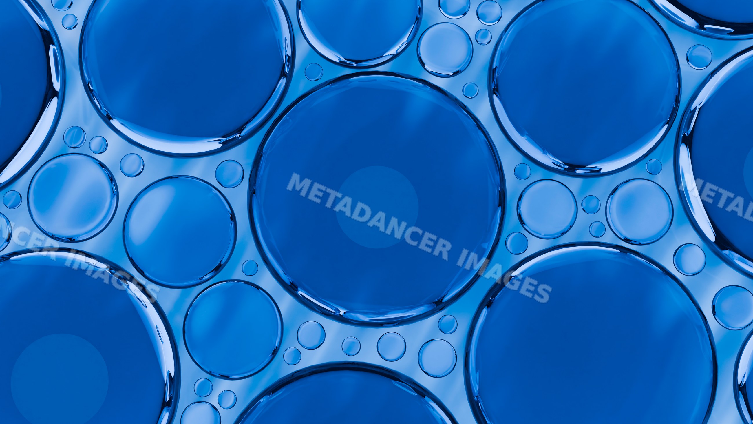 Close-up abstract of blue liquid bubbles forming circular patterns