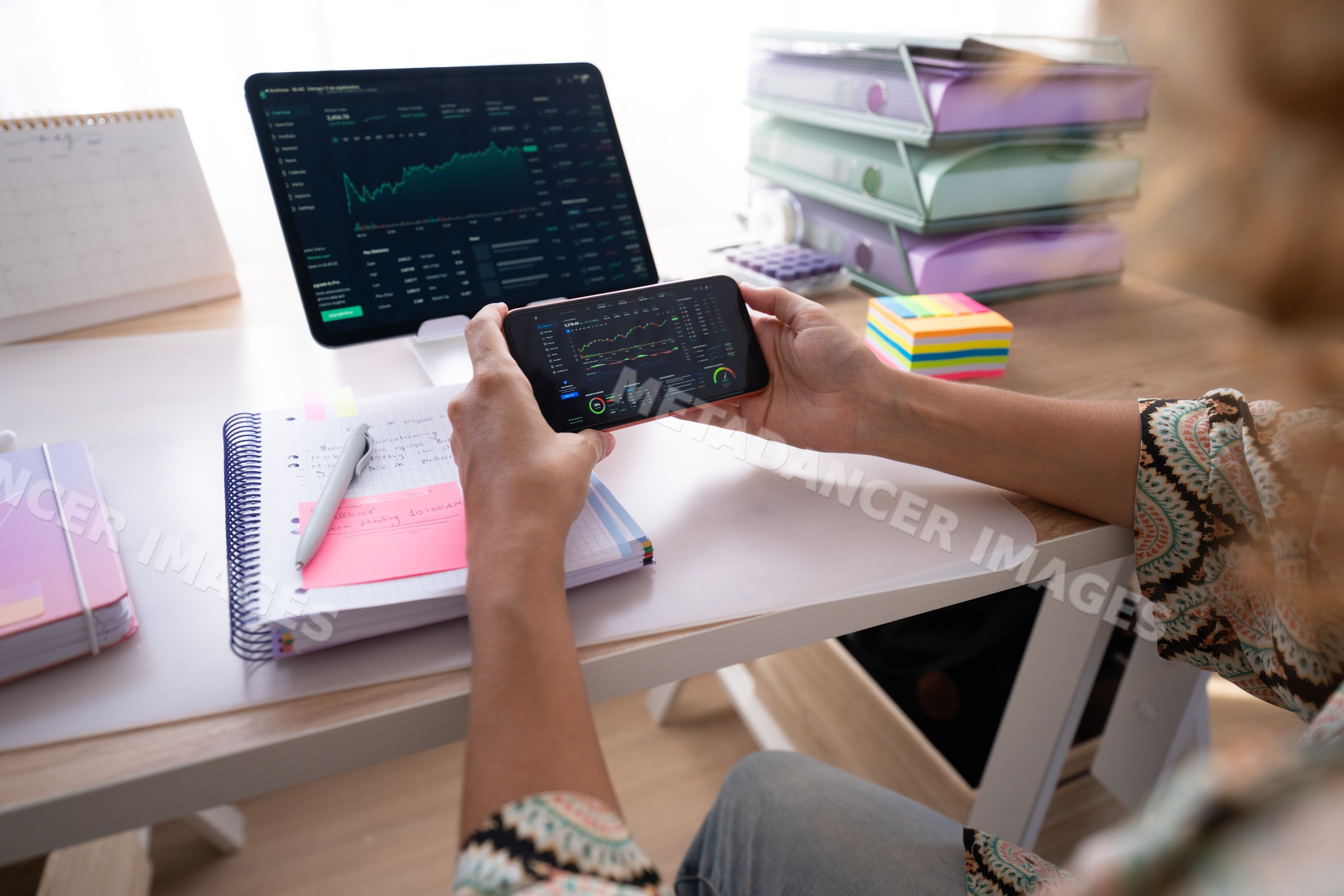 White woman reviewing financial data on smartphone