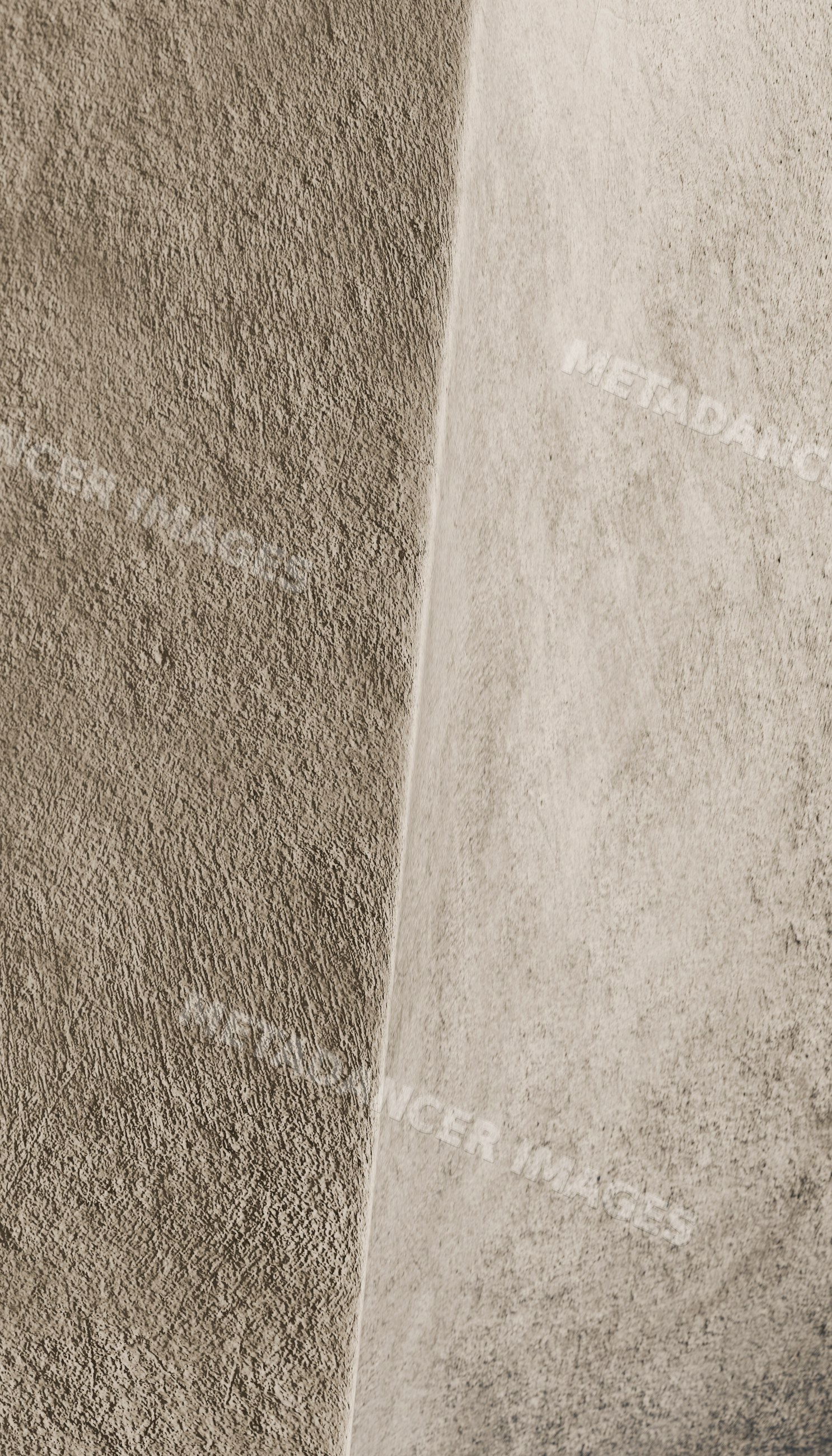 Close-up of textured concrete wall with two vertical panels