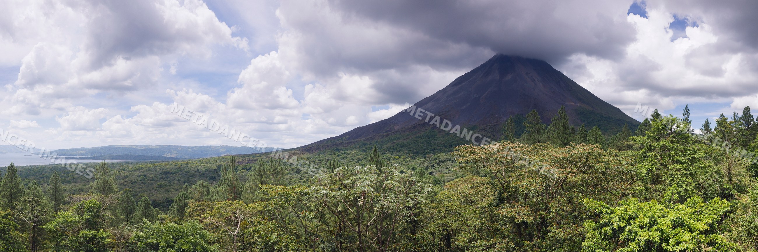Arenal volcano towering over tropical forest