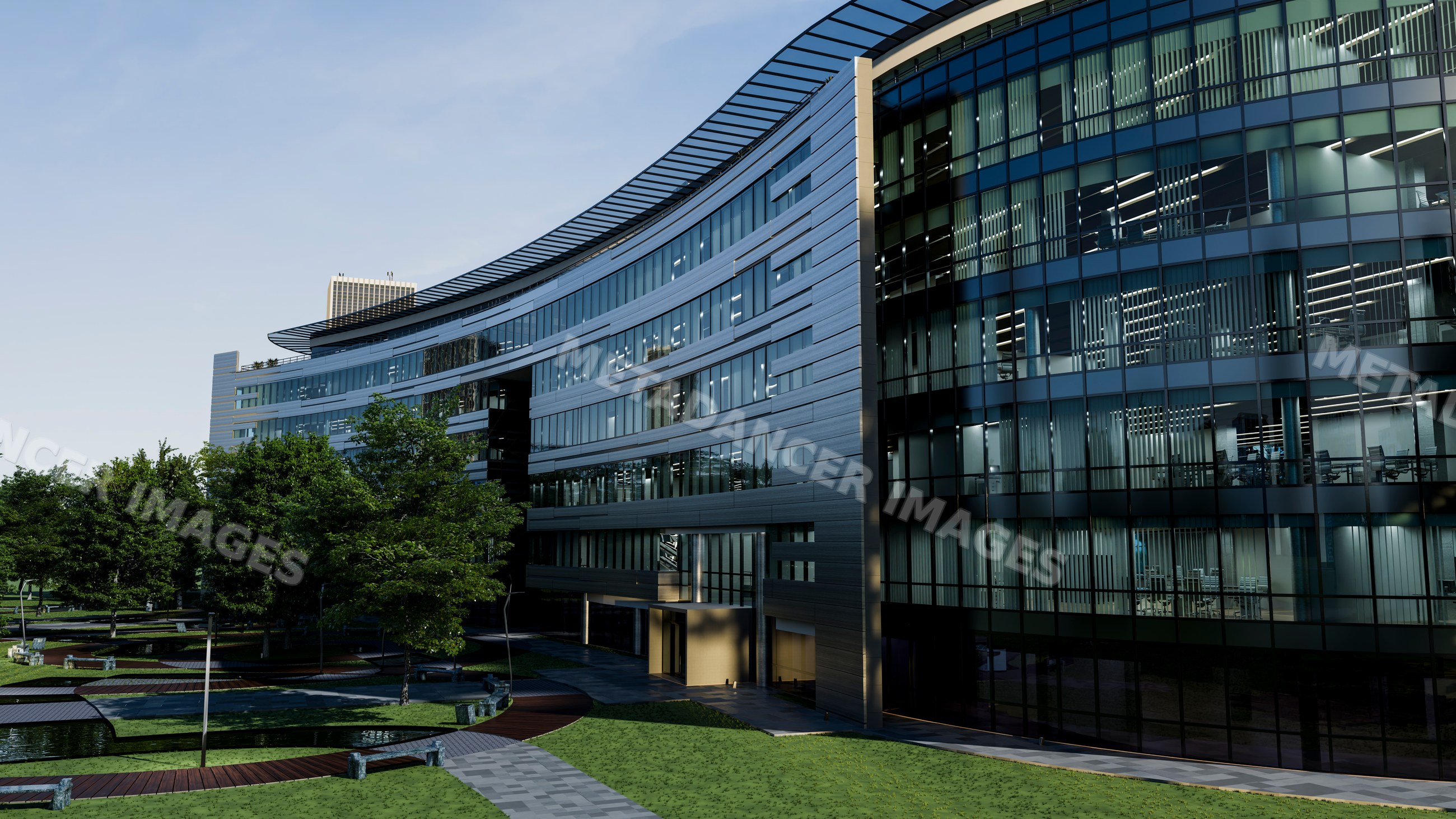 Modern curved office building with glass facade and surrounding green