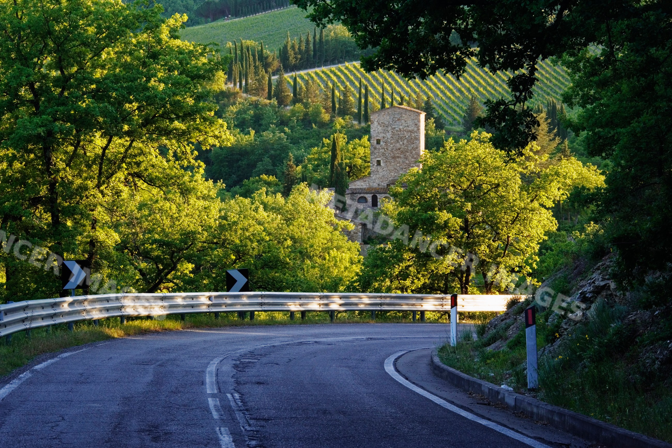 Curved rural road near stone farmhouse, italy