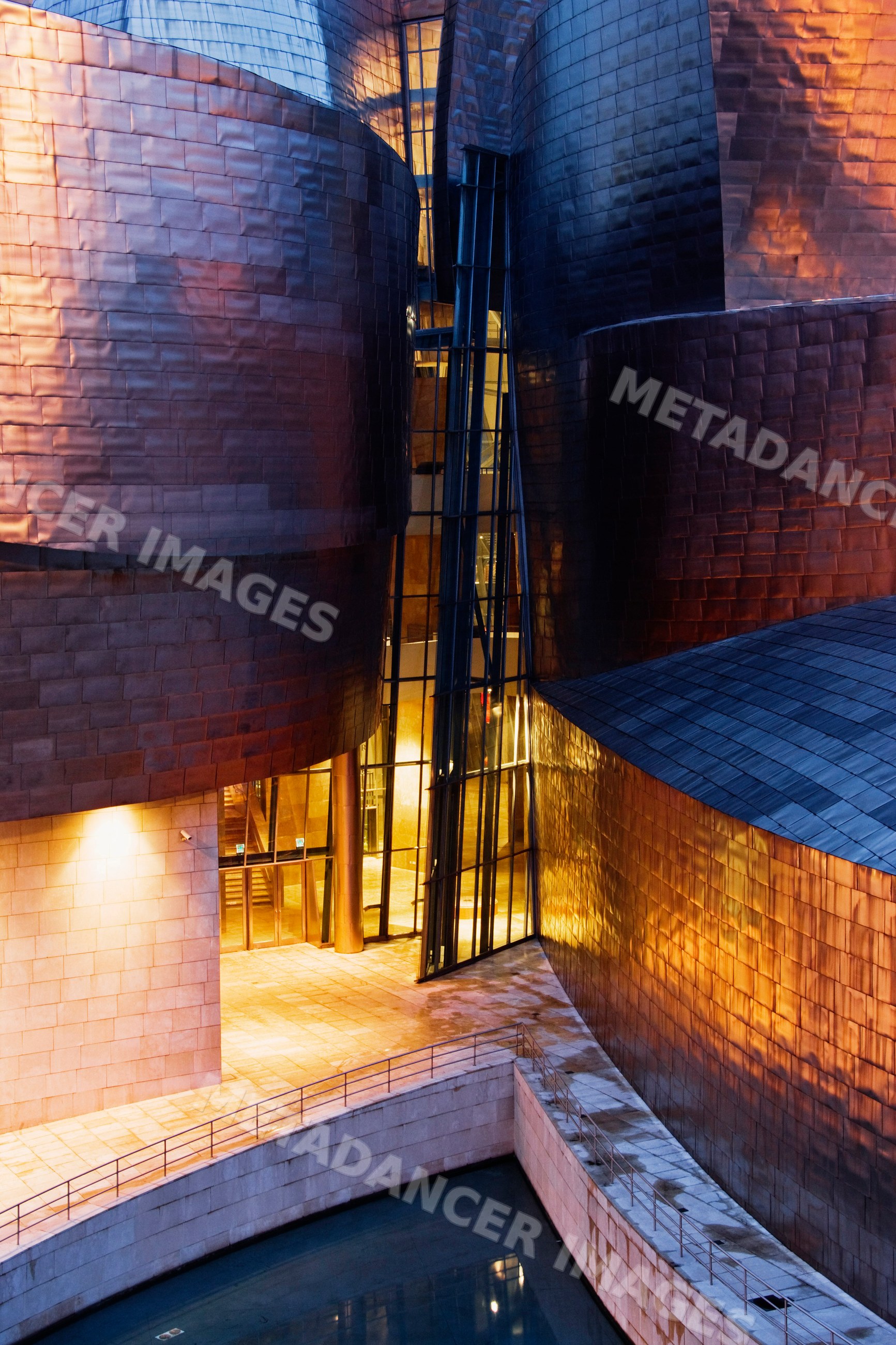 Curved metal architecture and glass windows of guggenheim museum