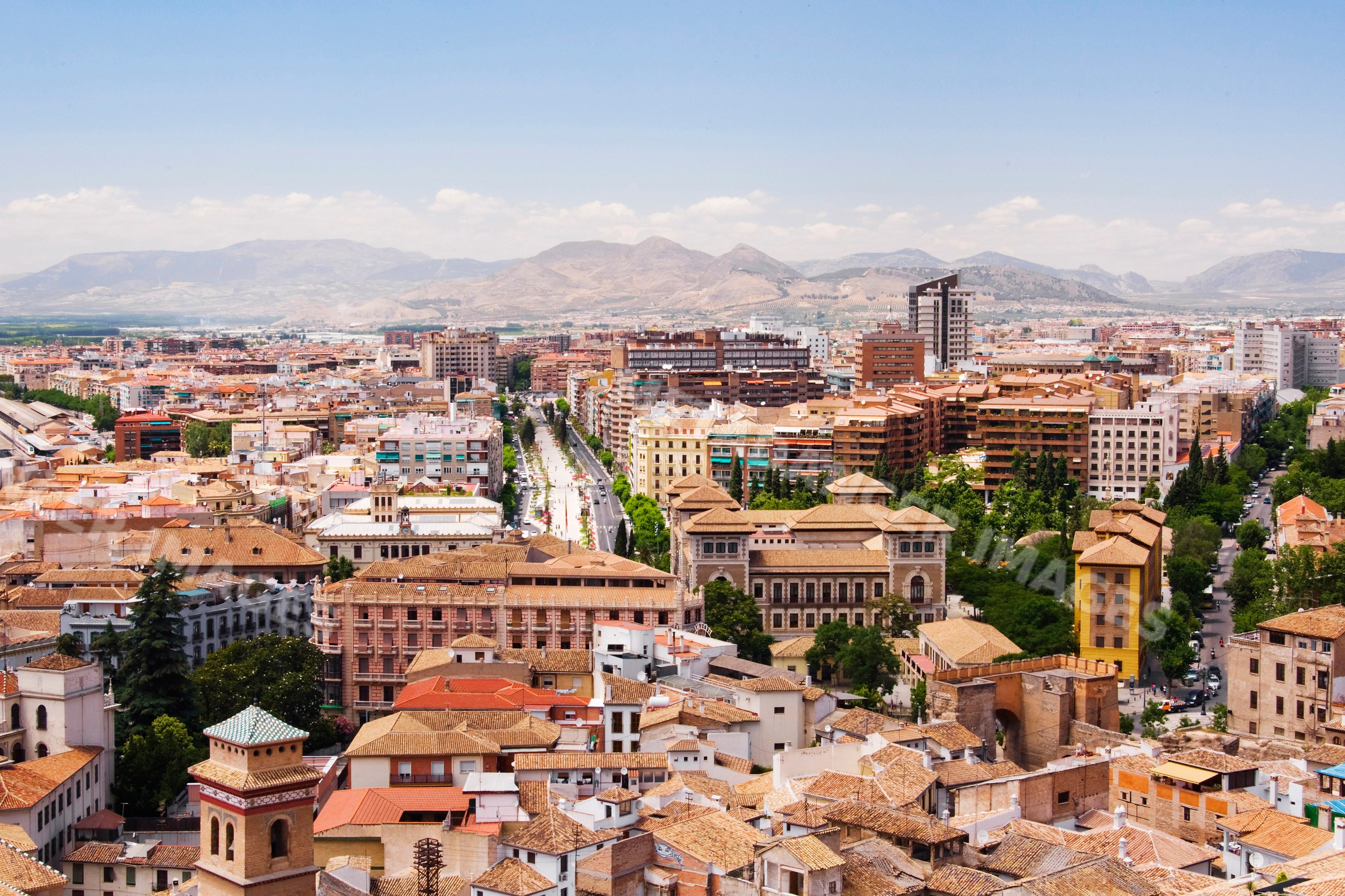 Cityscape view of andalucia with mountains and sunny sky