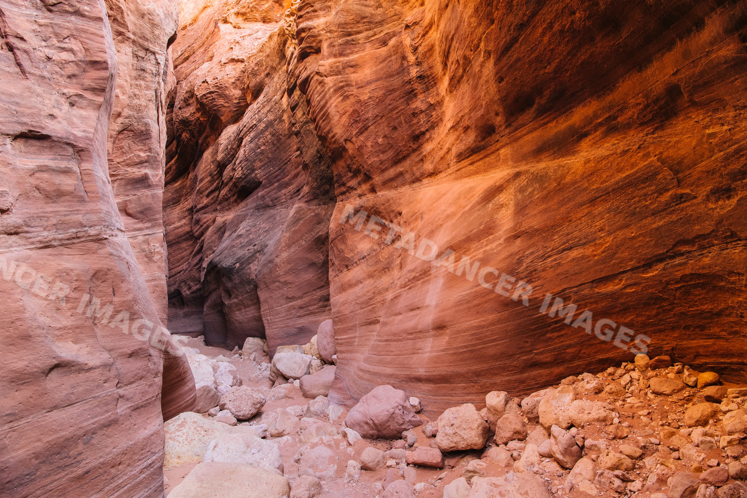 Slot canyon with red sandstone rock walls in Utah desert