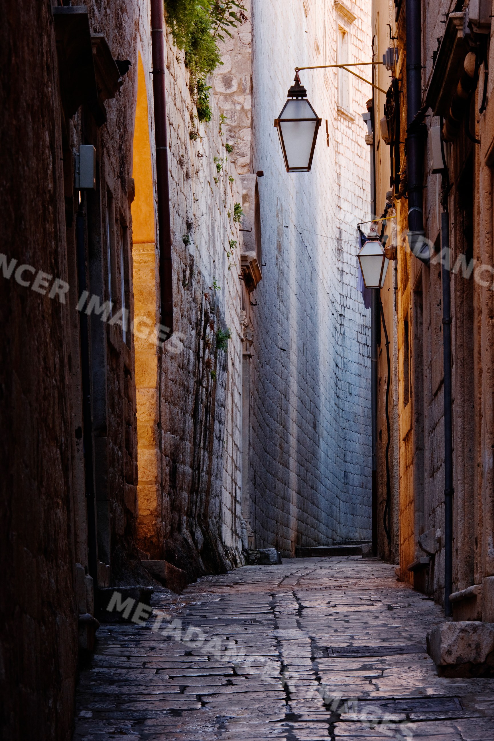Stone alley with street lamps