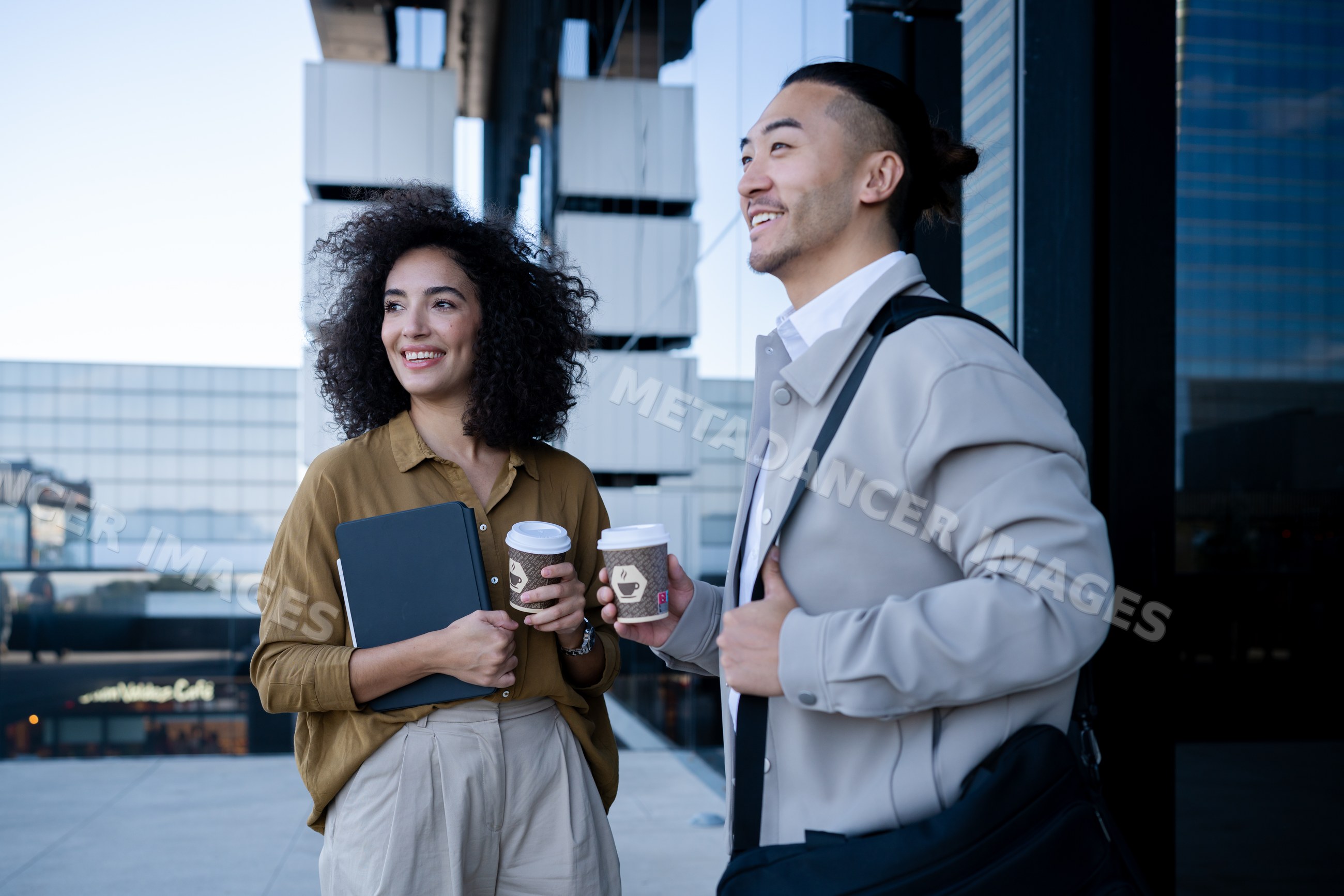 Office workers enjoying coffee break on outdoor urban terrace