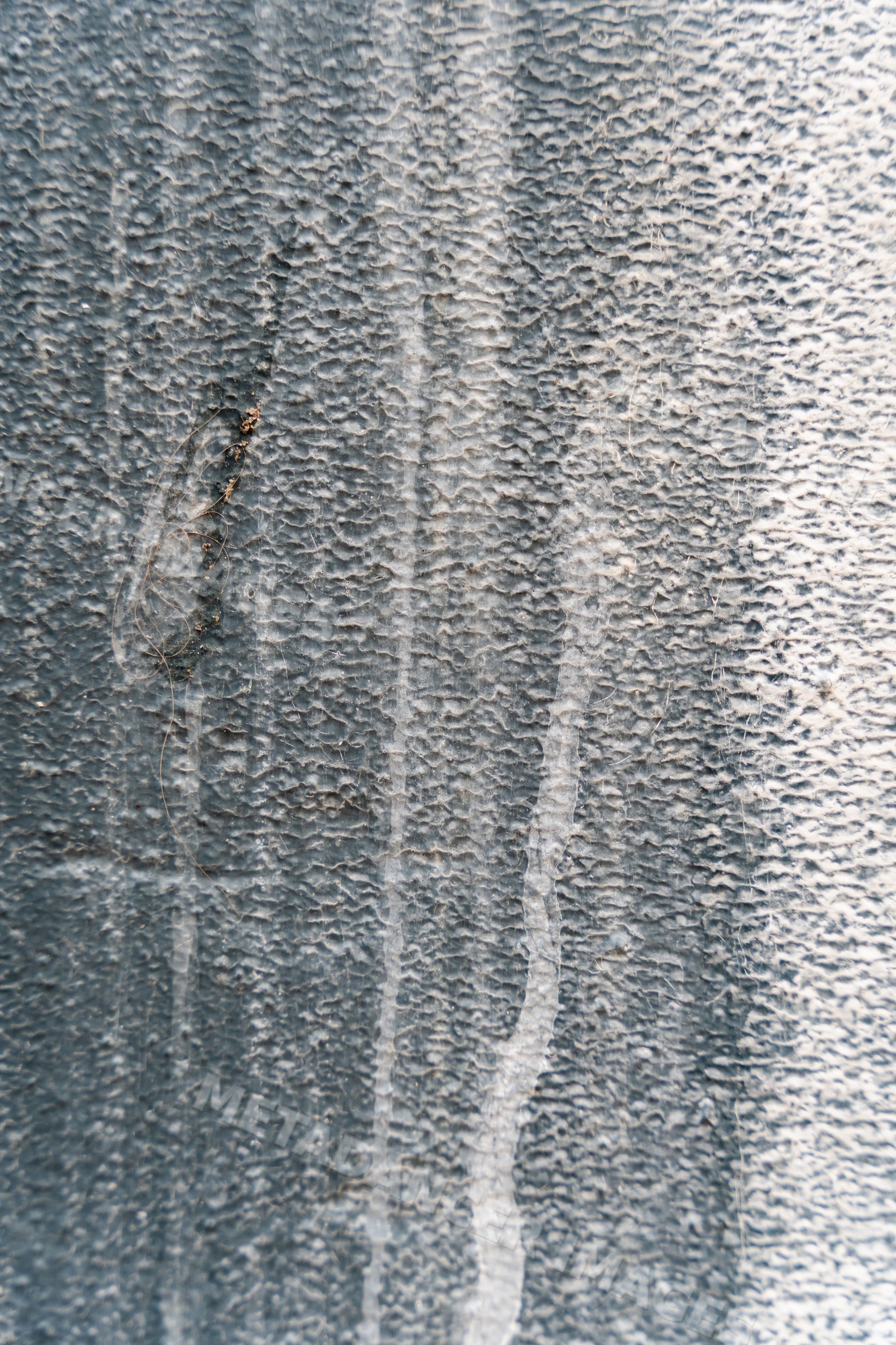 Close-up of textured weathered surface with abstract vertical streaks