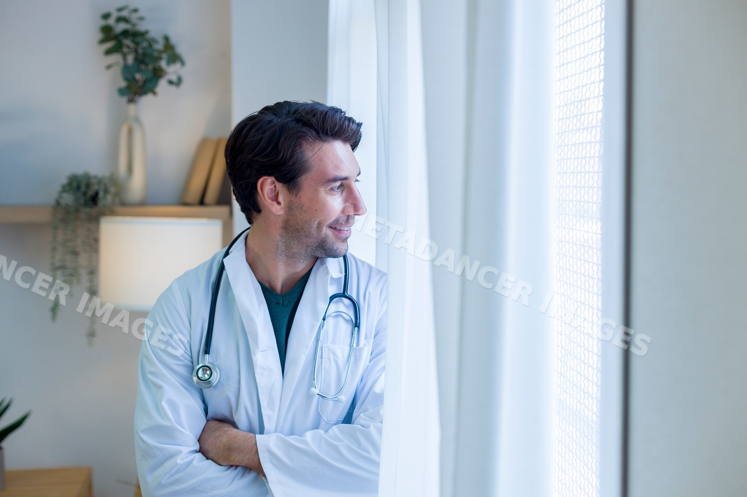 Doctor looking outside window in a home environment