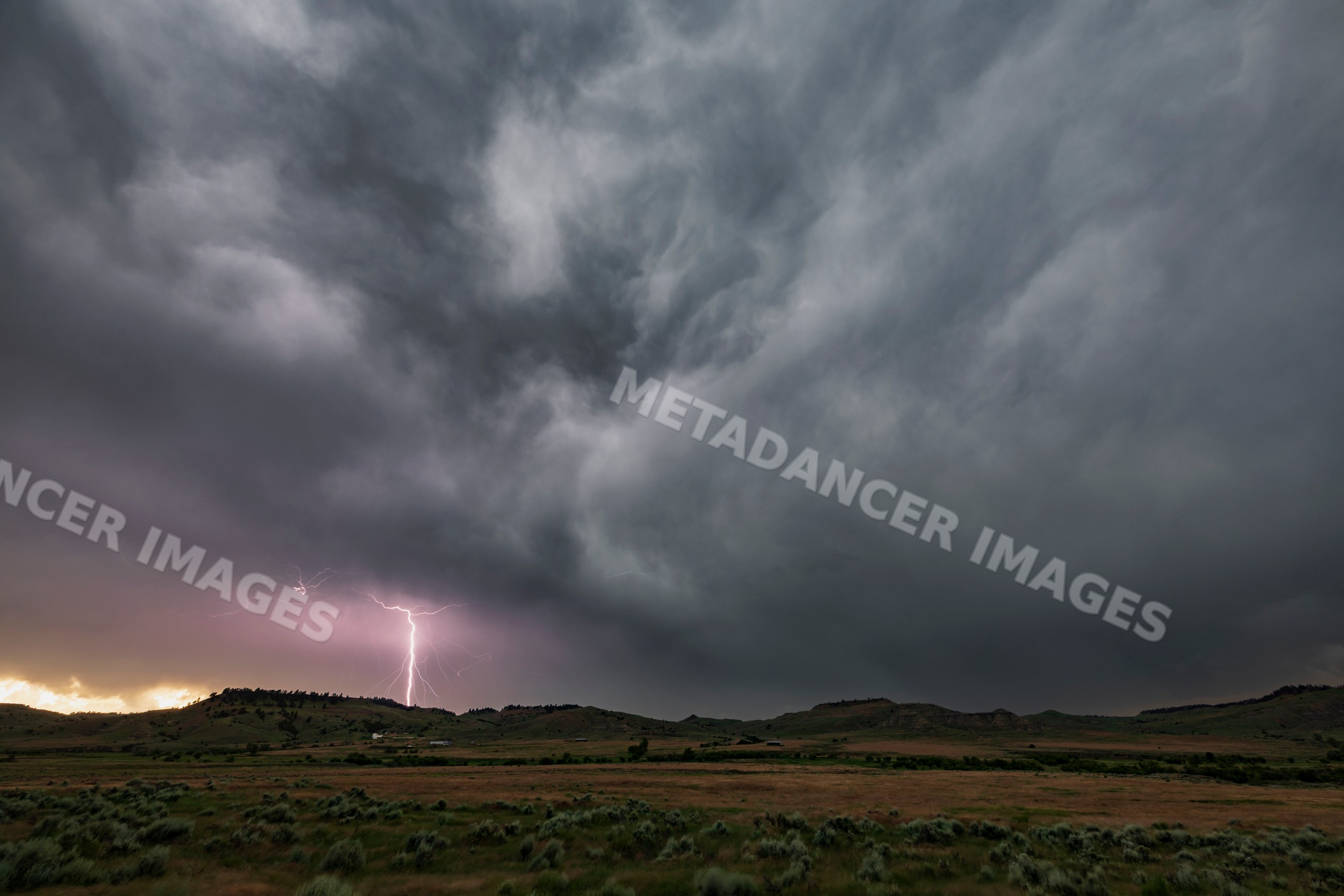 Lightning strike under dark storm clouds near gillette wyoming USA