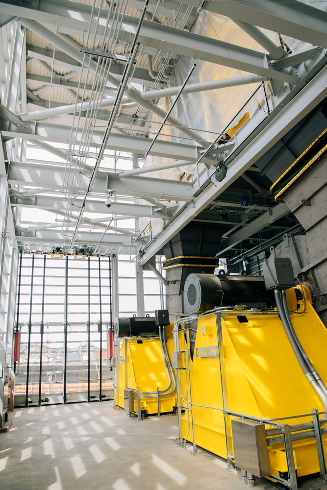 Large yellow industrial machines with electric motors inside a factory