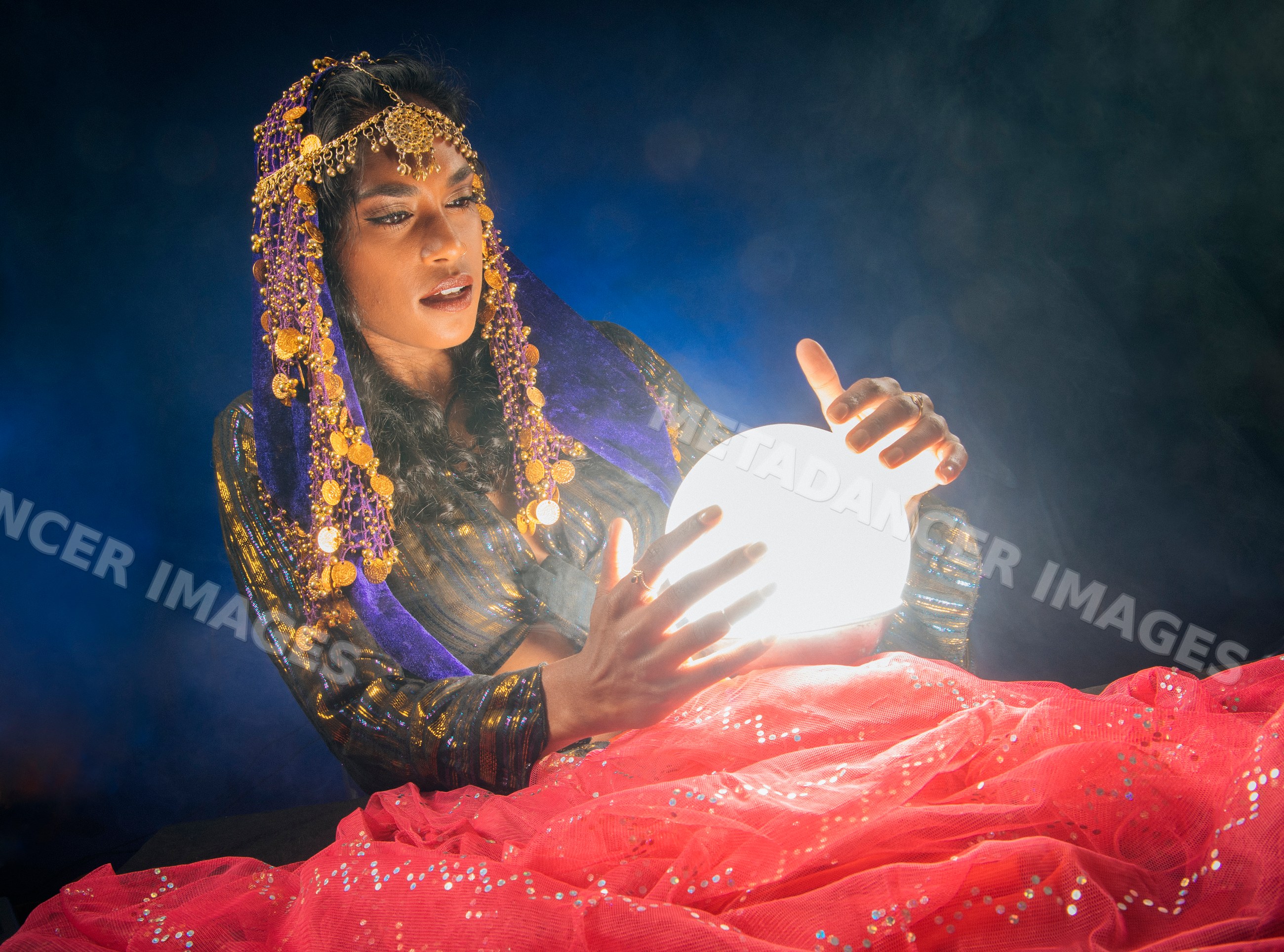 A South Asian woman fortune teller gazes