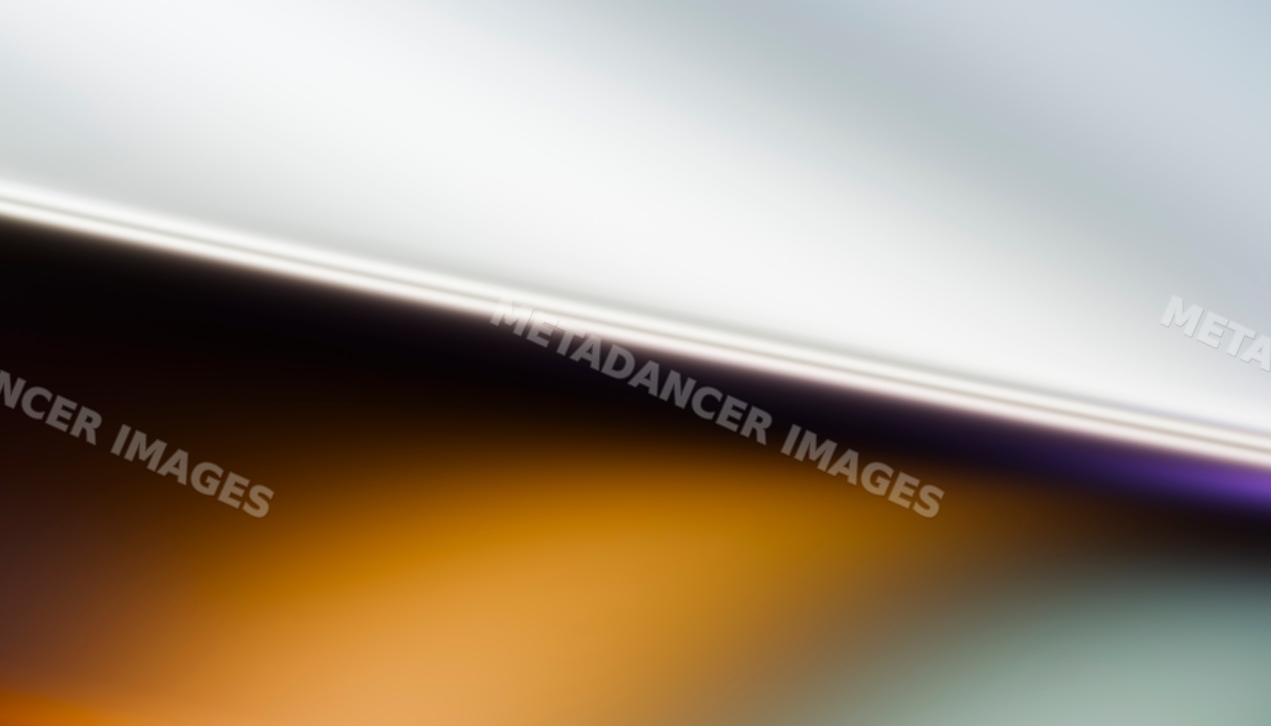 Abstract gradient of warm orange blending smoothly into soft gray