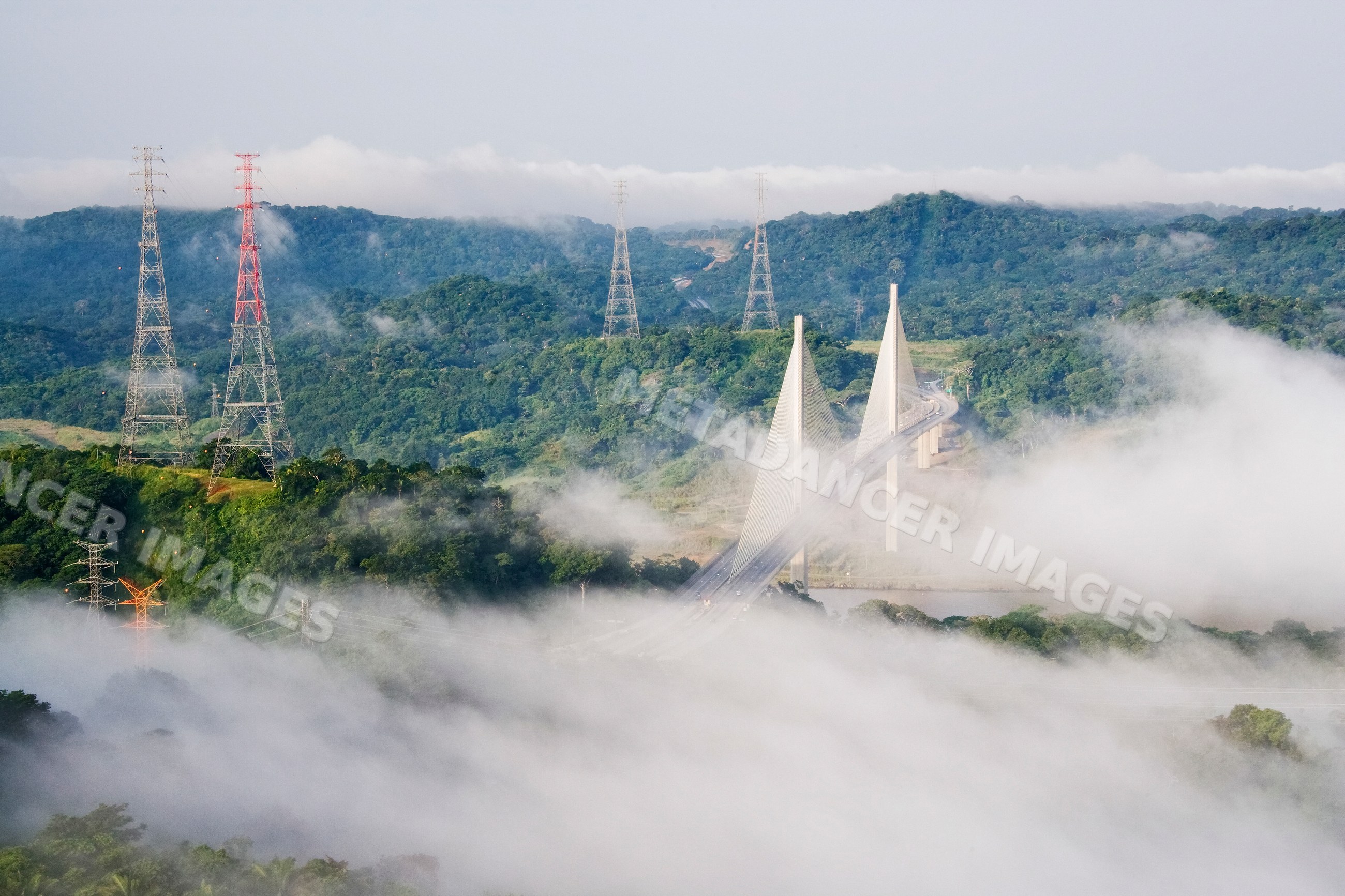 New millennium panama canal bridge over misty lush hills