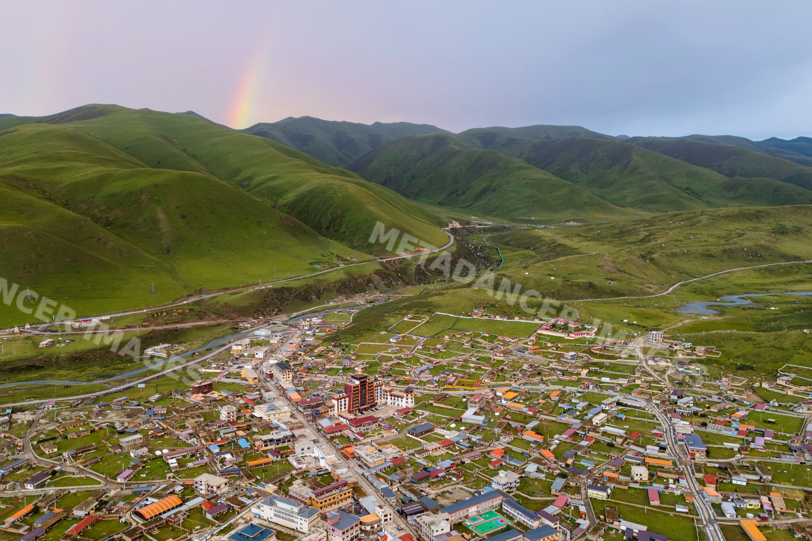 Zhuqing village in green mountains with Sunset rainbow