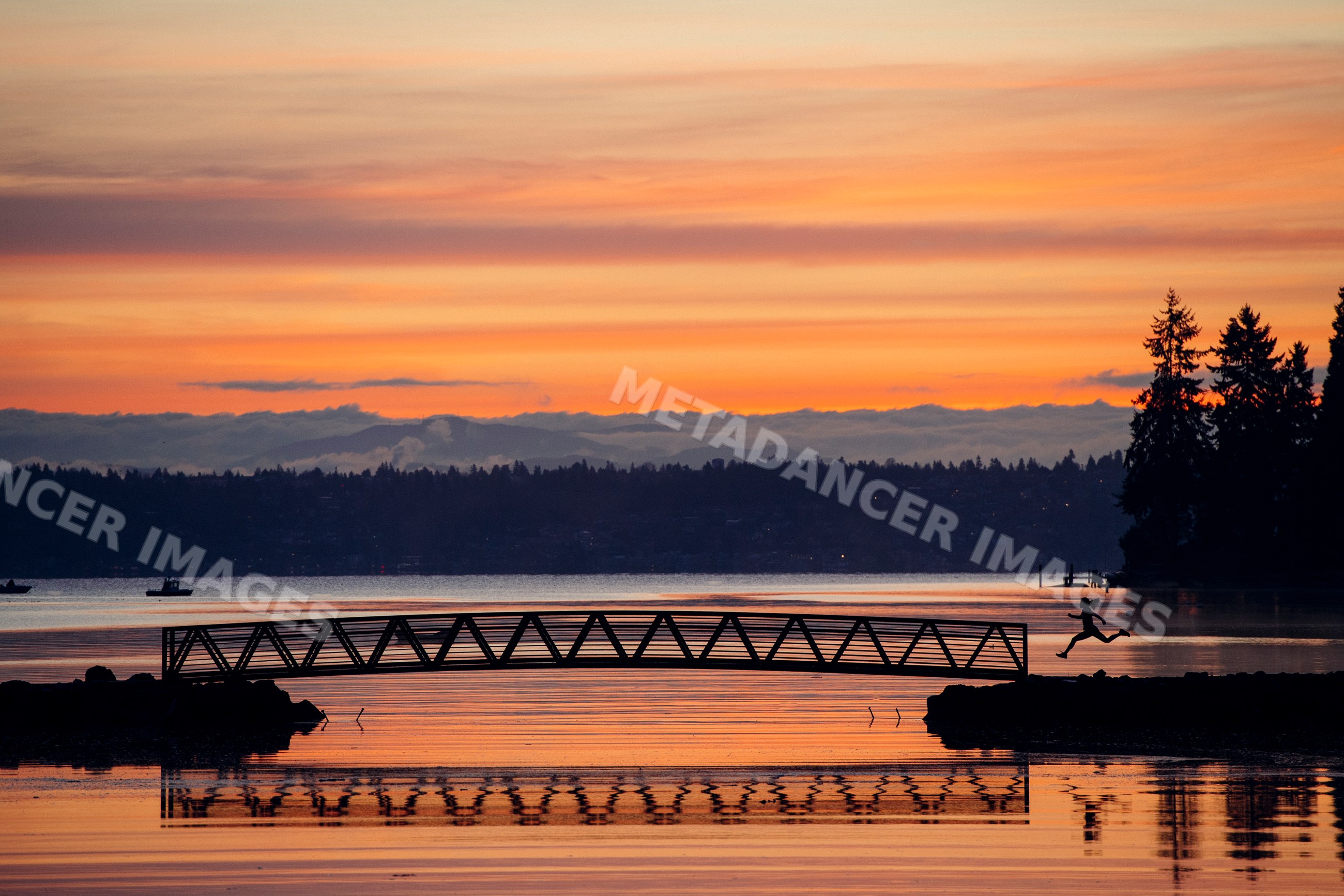Silhouette of Pacific Islander person jumping by dock