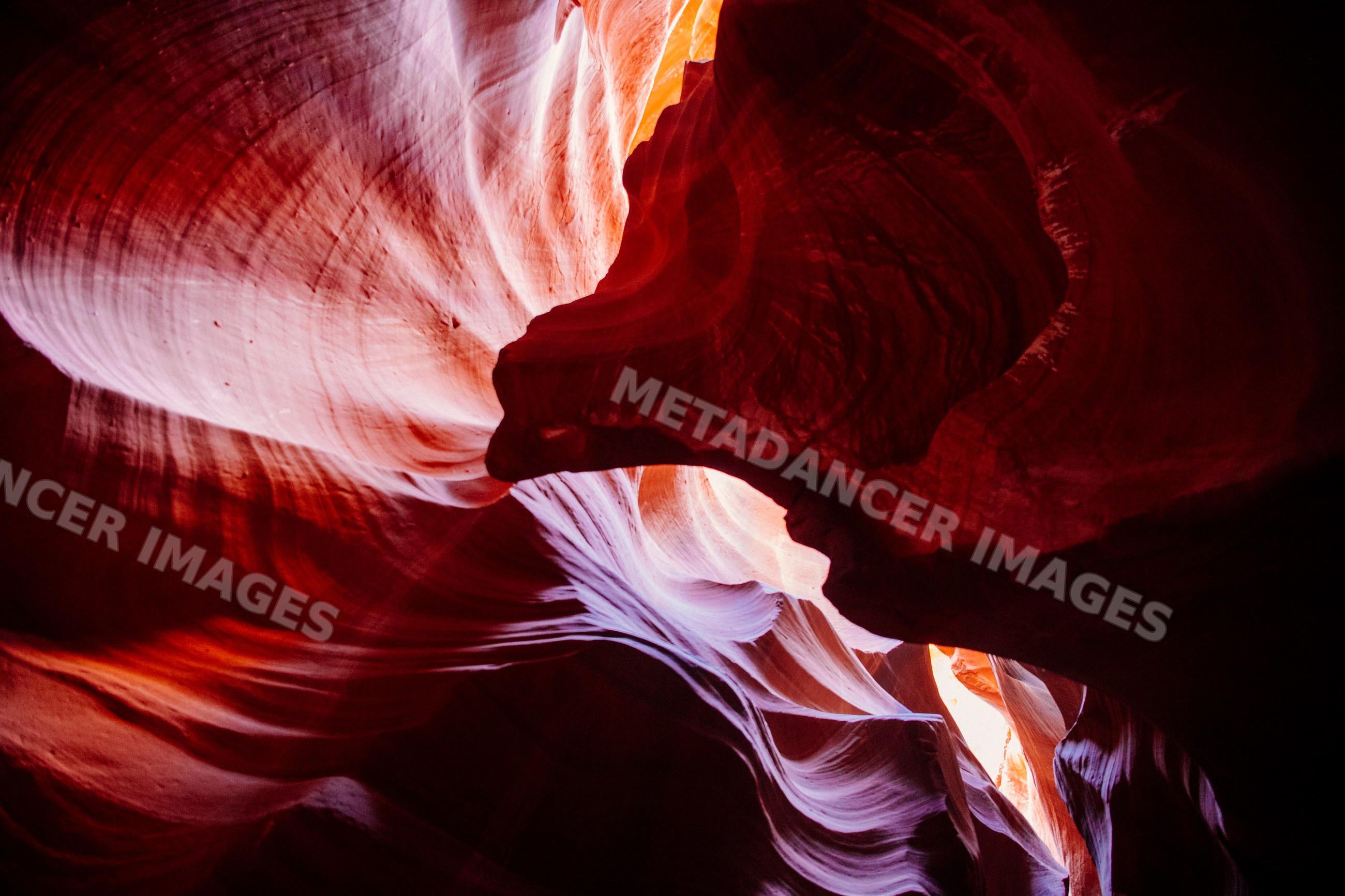Curved sandstone formations illuminated by light