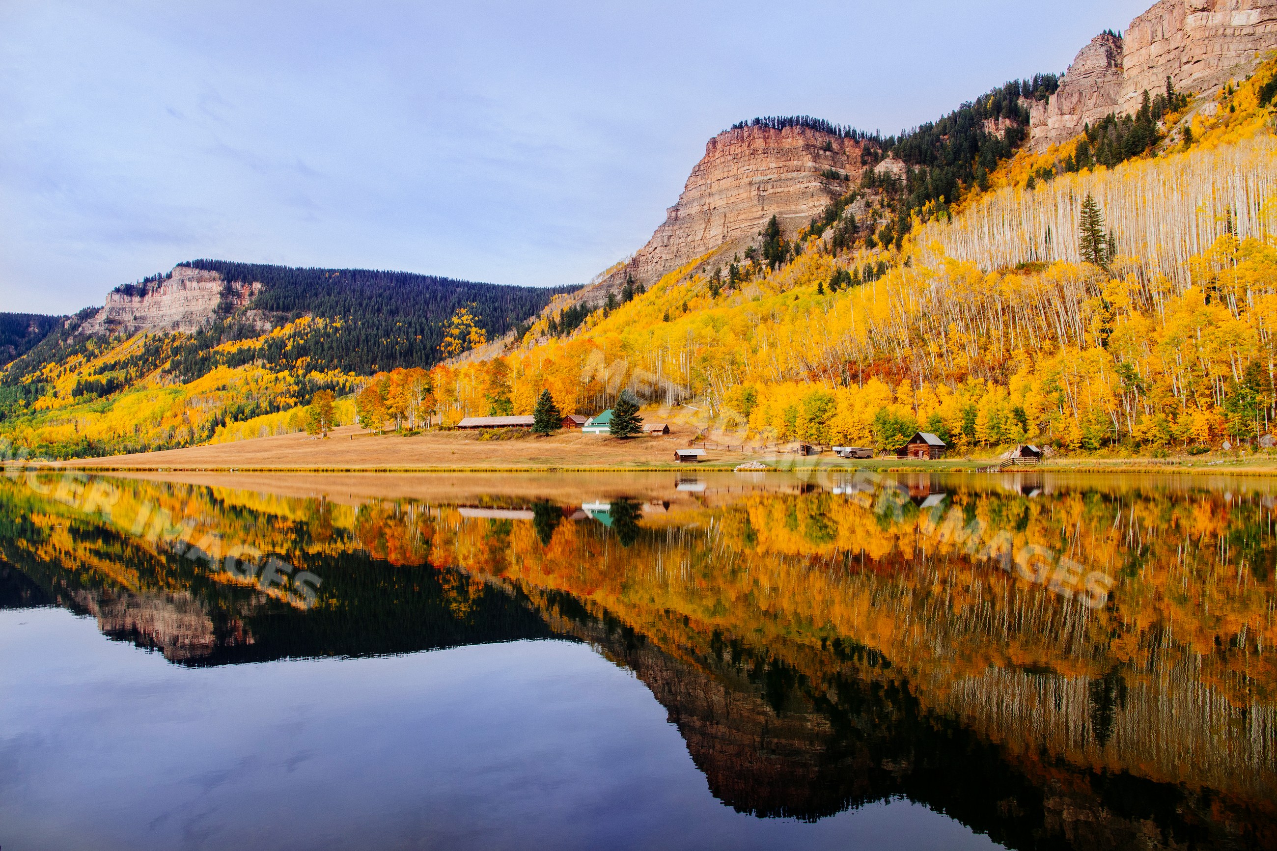 Mountain landscape with autumn trees reflected