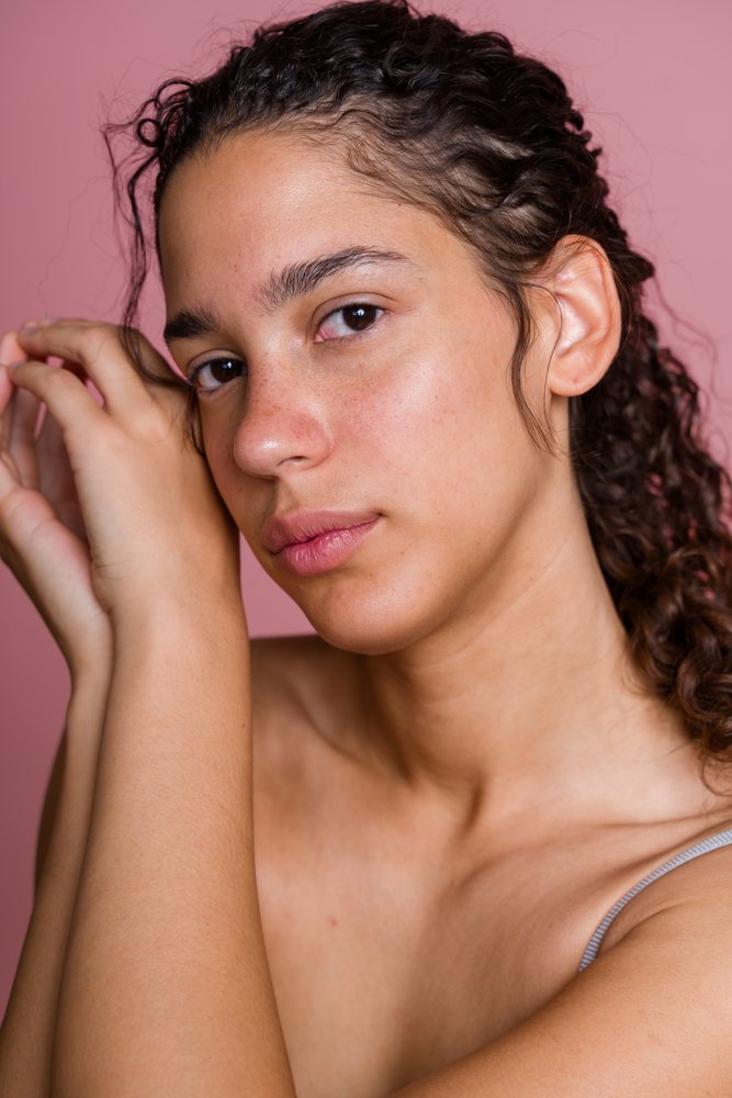 Hispanic woman with natural skin and curly hair in beauty shoot