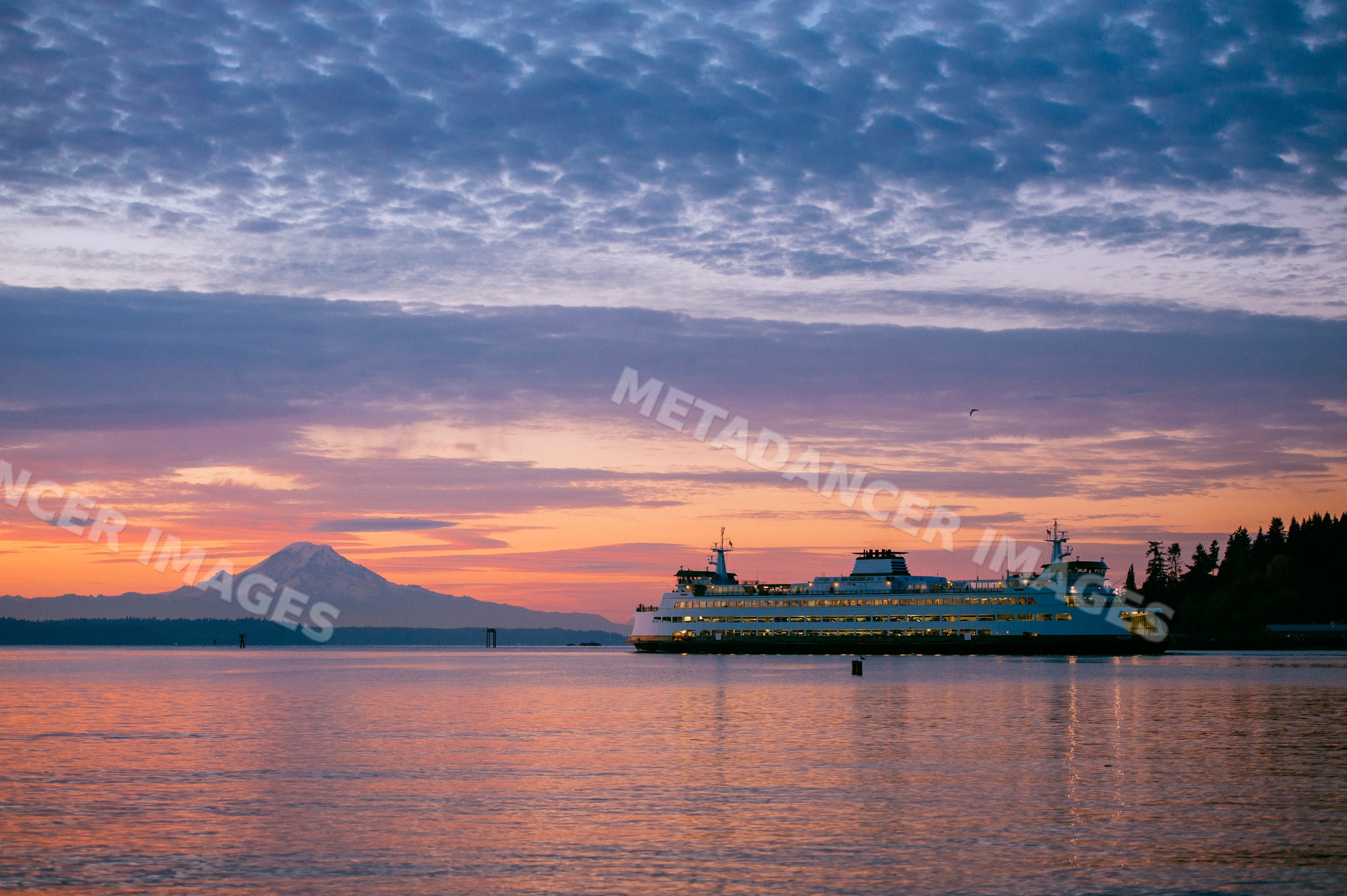 Seattle ferry at sunset near Bainbridge Island with mount rainier