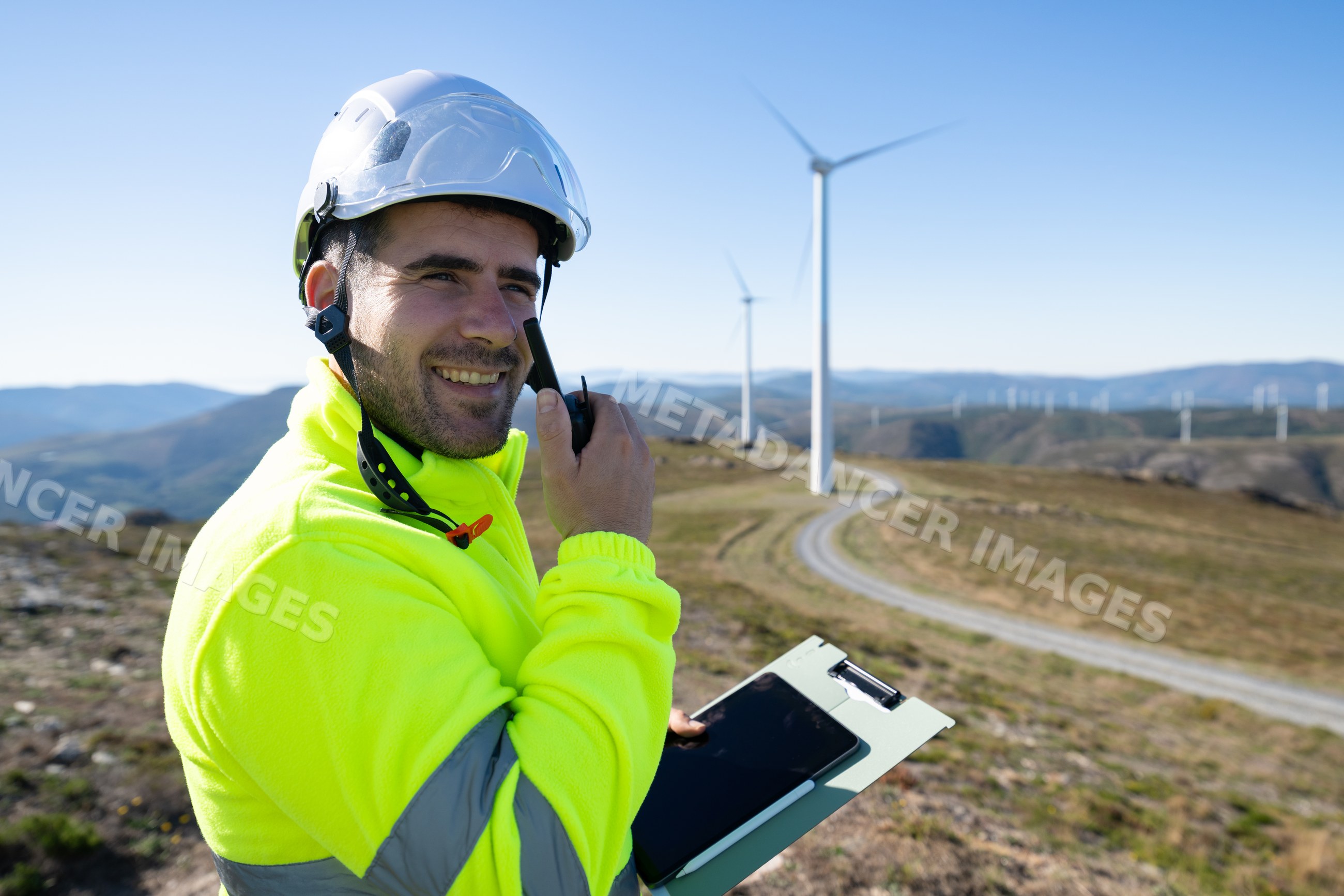 Engineer communicating at wind farm in Galicia Spain