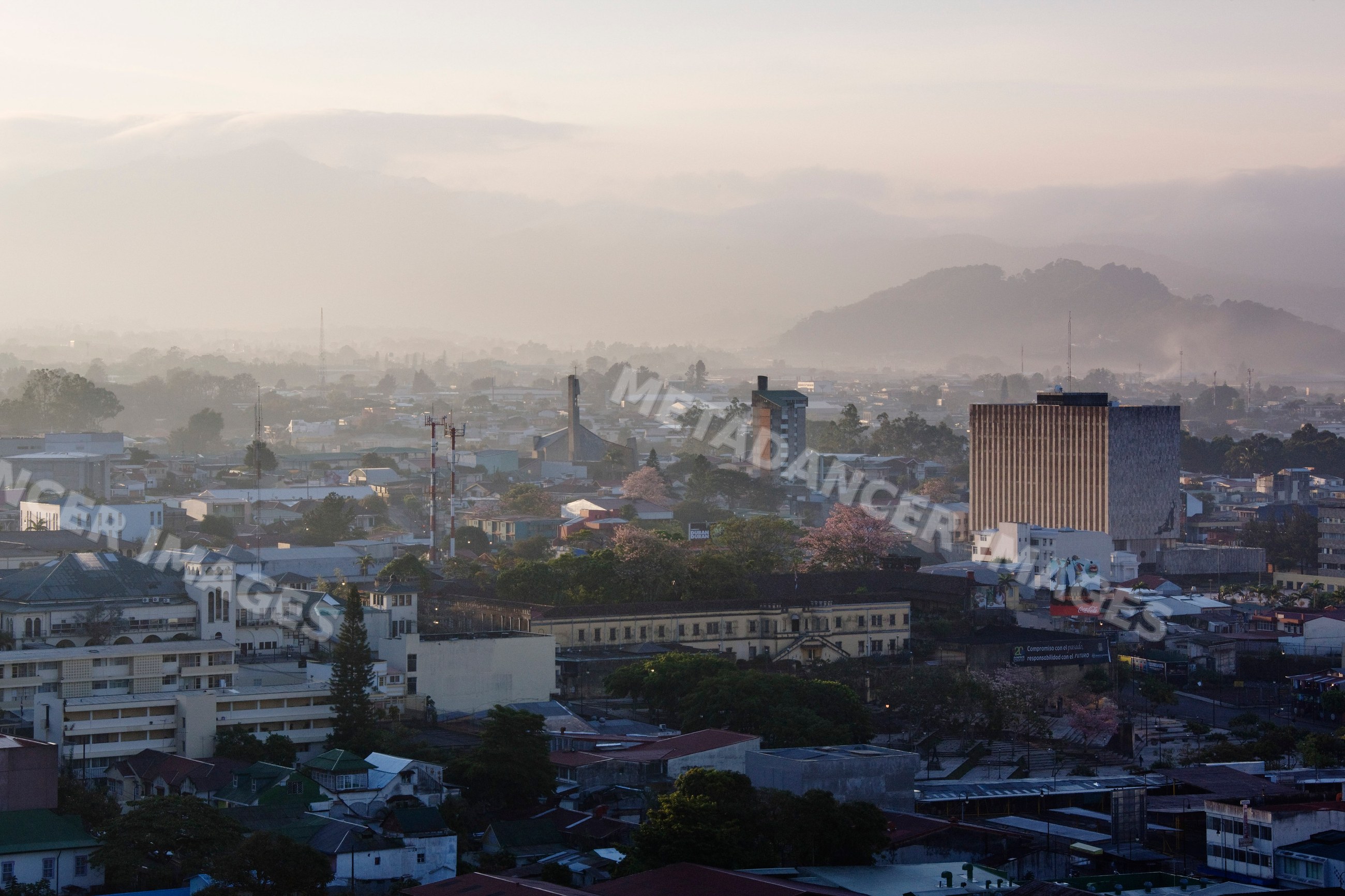 Cityscape of san jose, costa rica with foggy hills and urban buildings