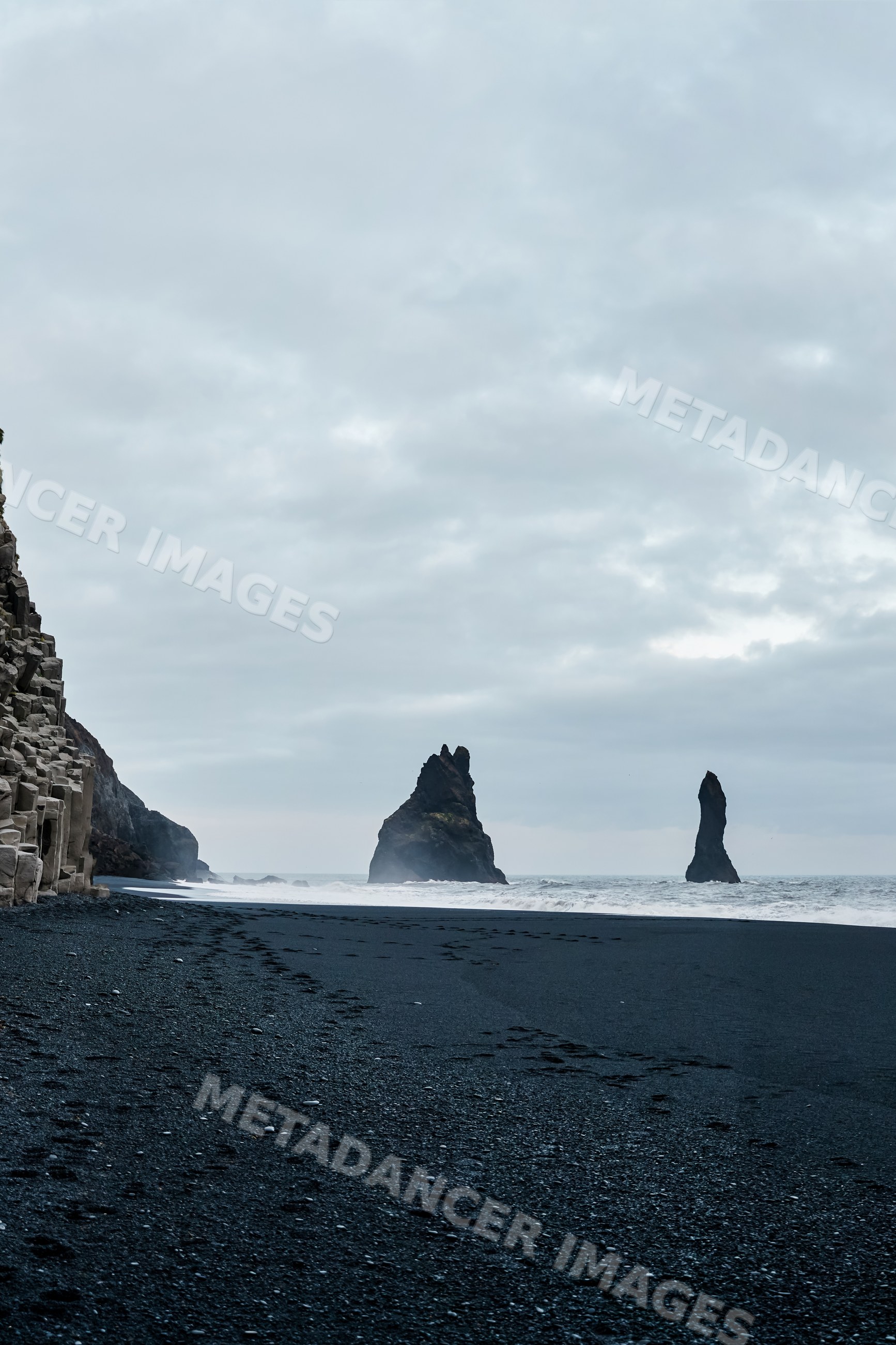Black sand beach with basalt rock formations