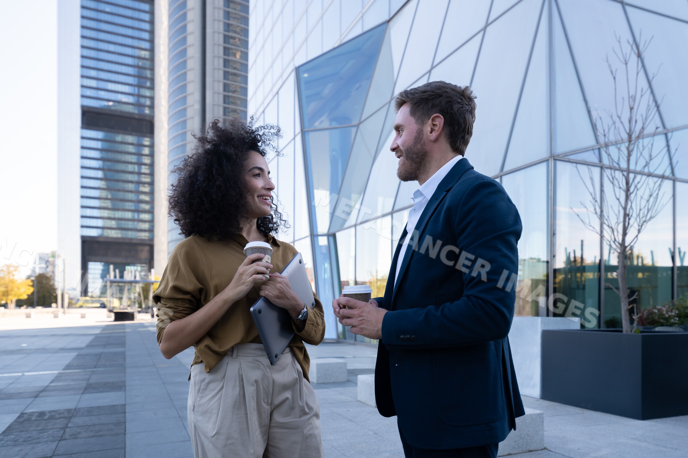 Business white people sharing coffee outside office building