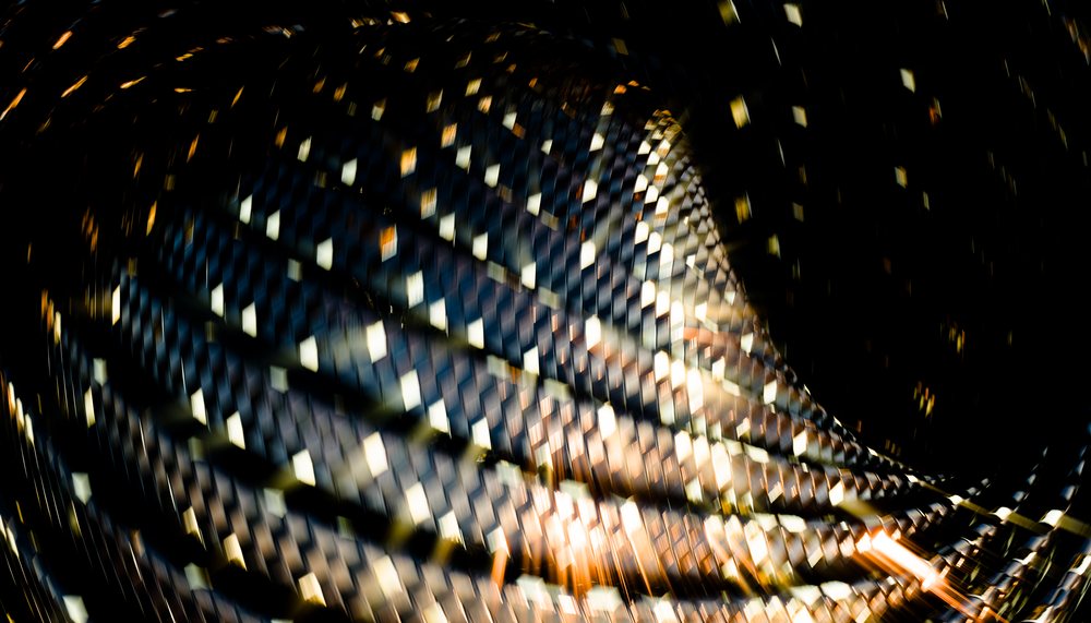 Abstract digital rendering of a twisted woven pattern with metallic