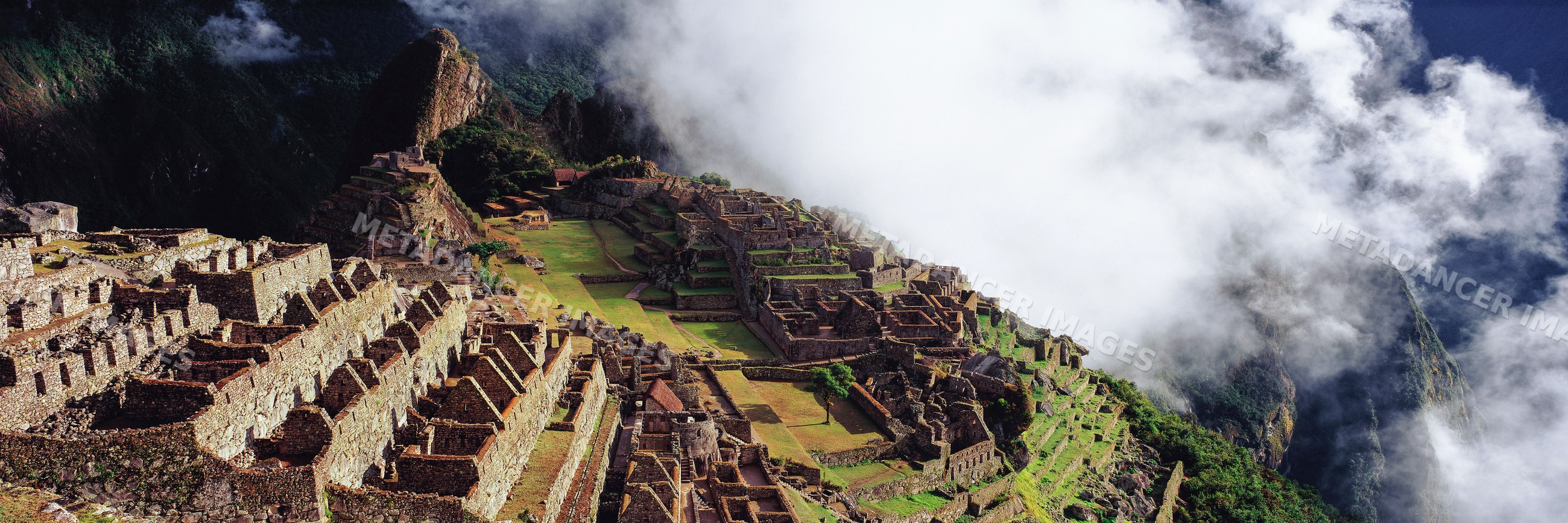 Machu picchu ruins enveloped in mist andes mountains
