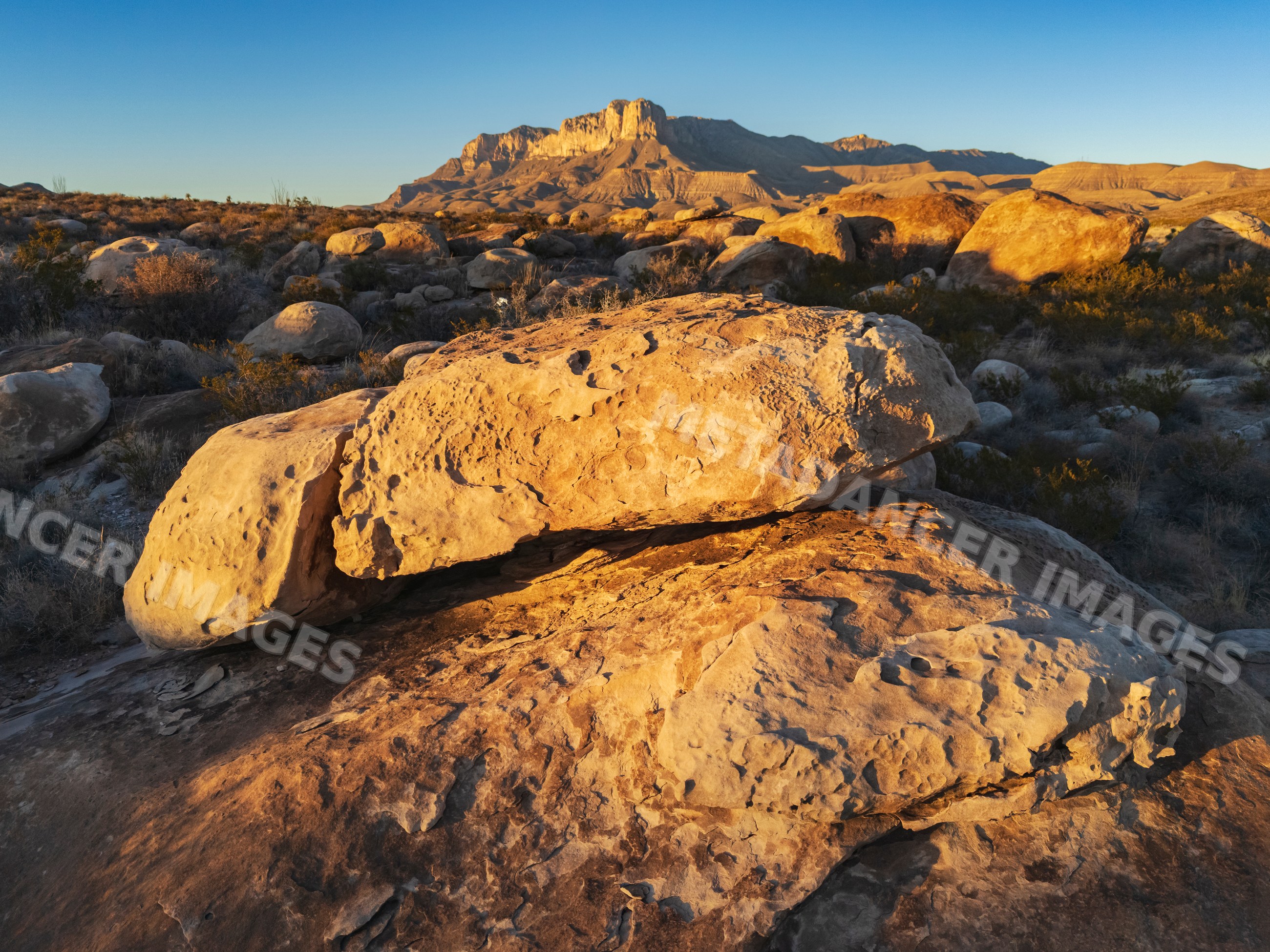 Boulders in desert landscape with El Capitán mountain in guadalupe