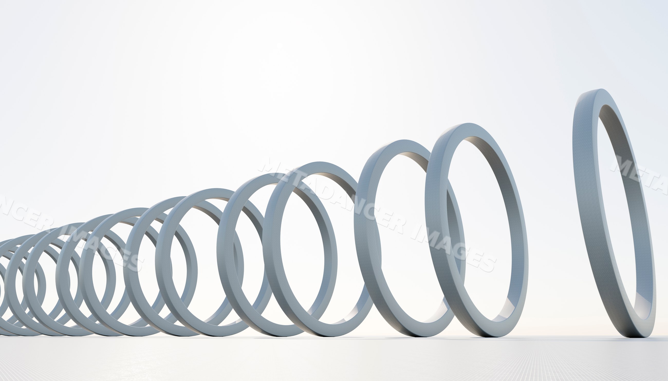 White rings arranged in a falling domino effect on a plain white