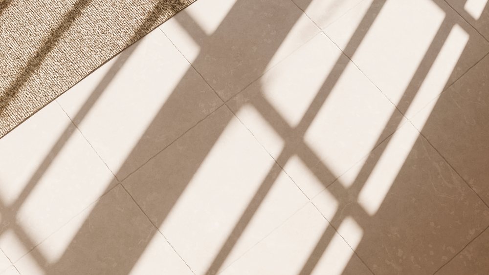 Tile floor with window shadows and textured rug in natural sunlight
