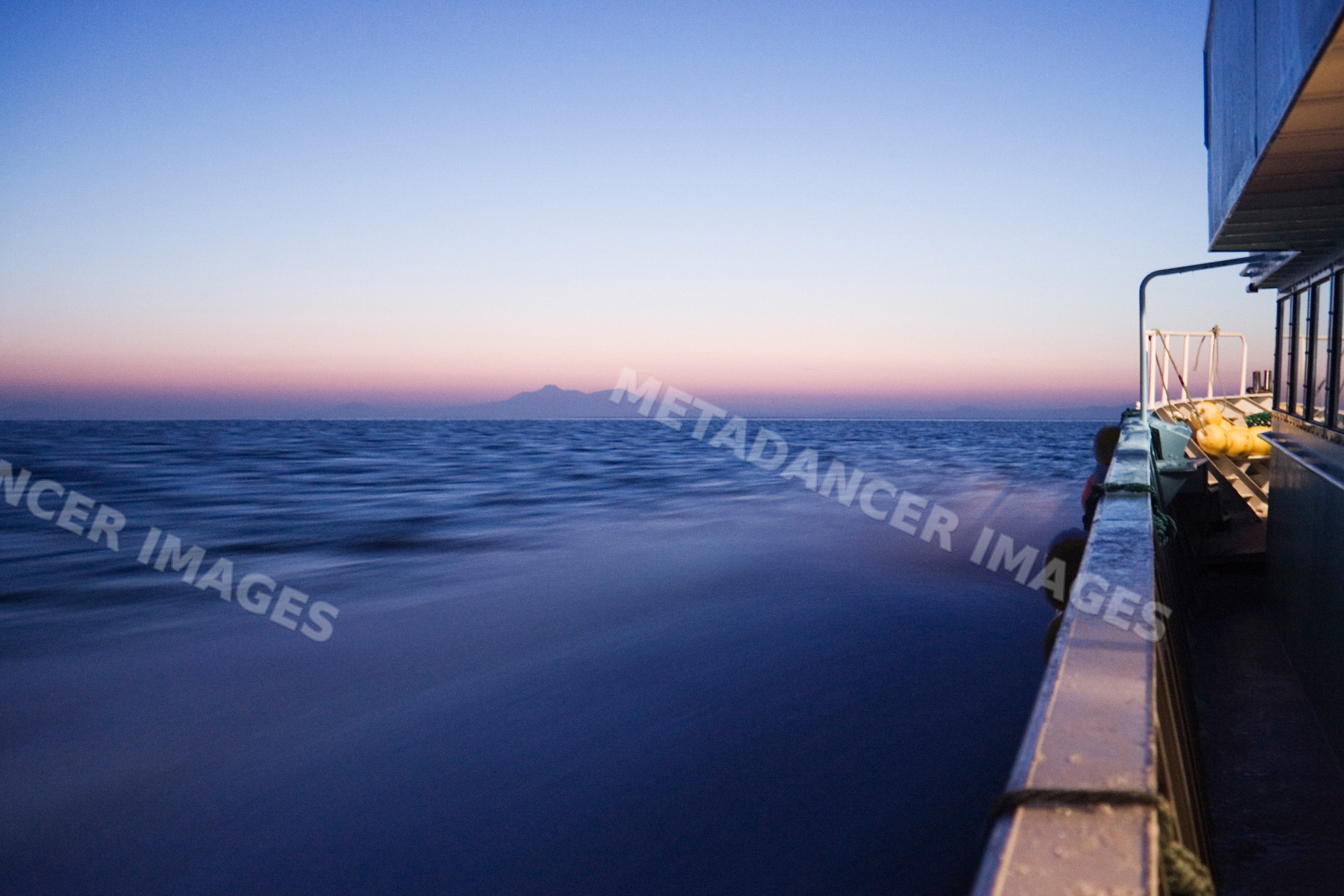 Sunset over nemuro channel from boat side railing, Japan