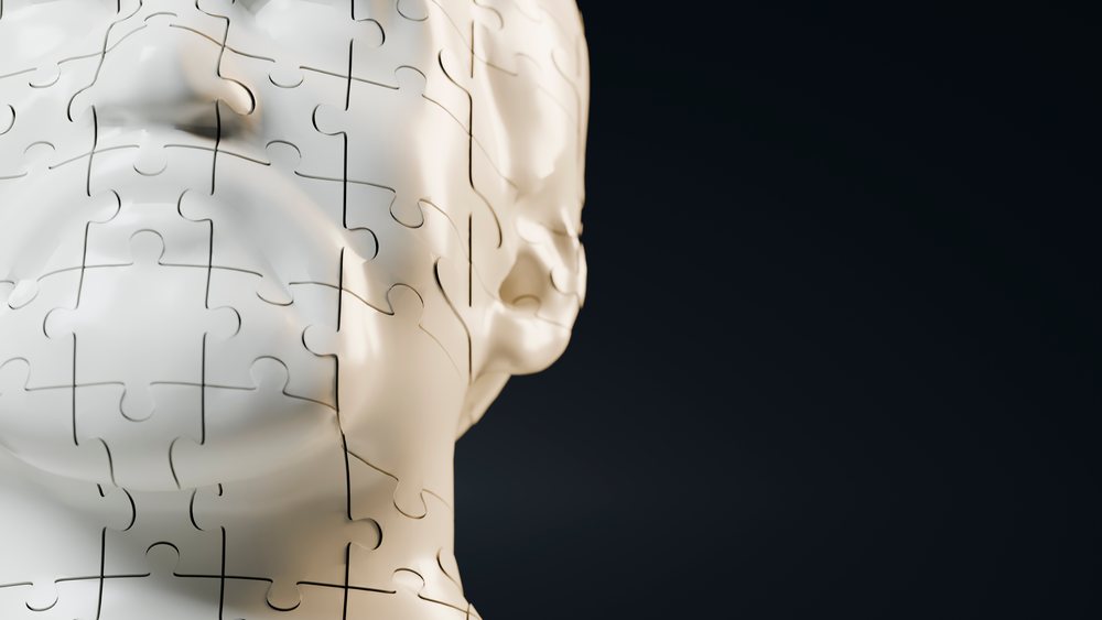 3d fragmented face puzzle sculpture close-up on black background