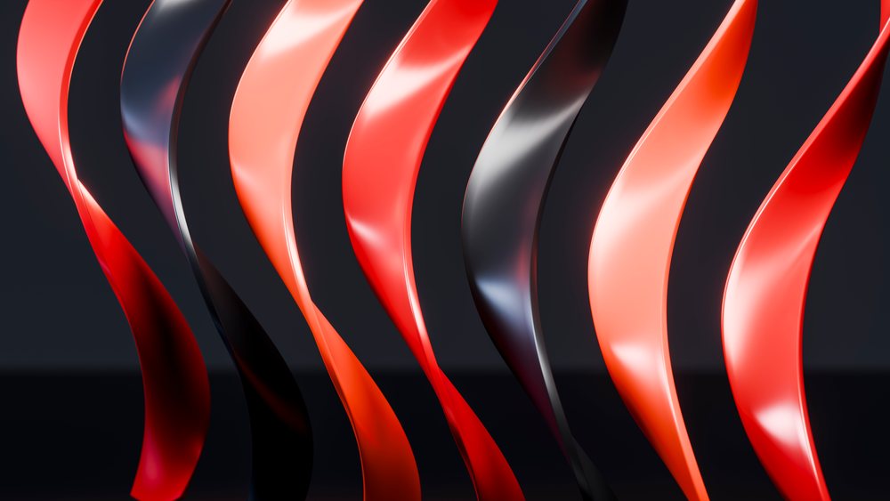 Curved red and black abstract sculptures with glossy surfaces