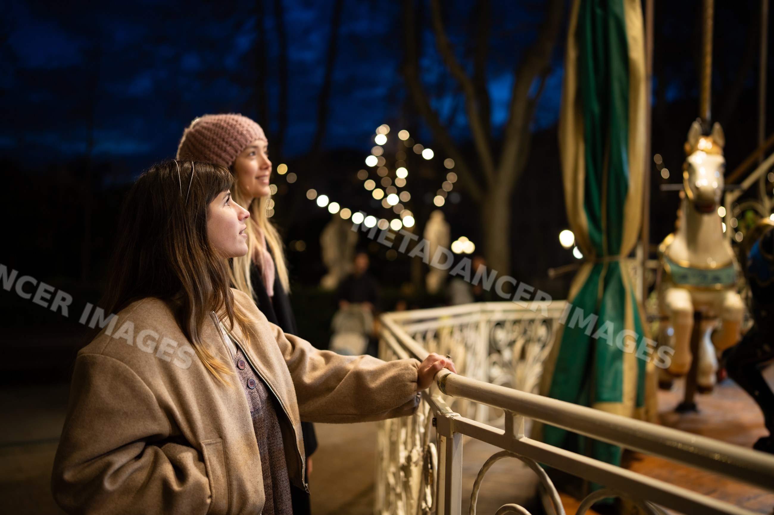 Two white women enjoying a carousel
