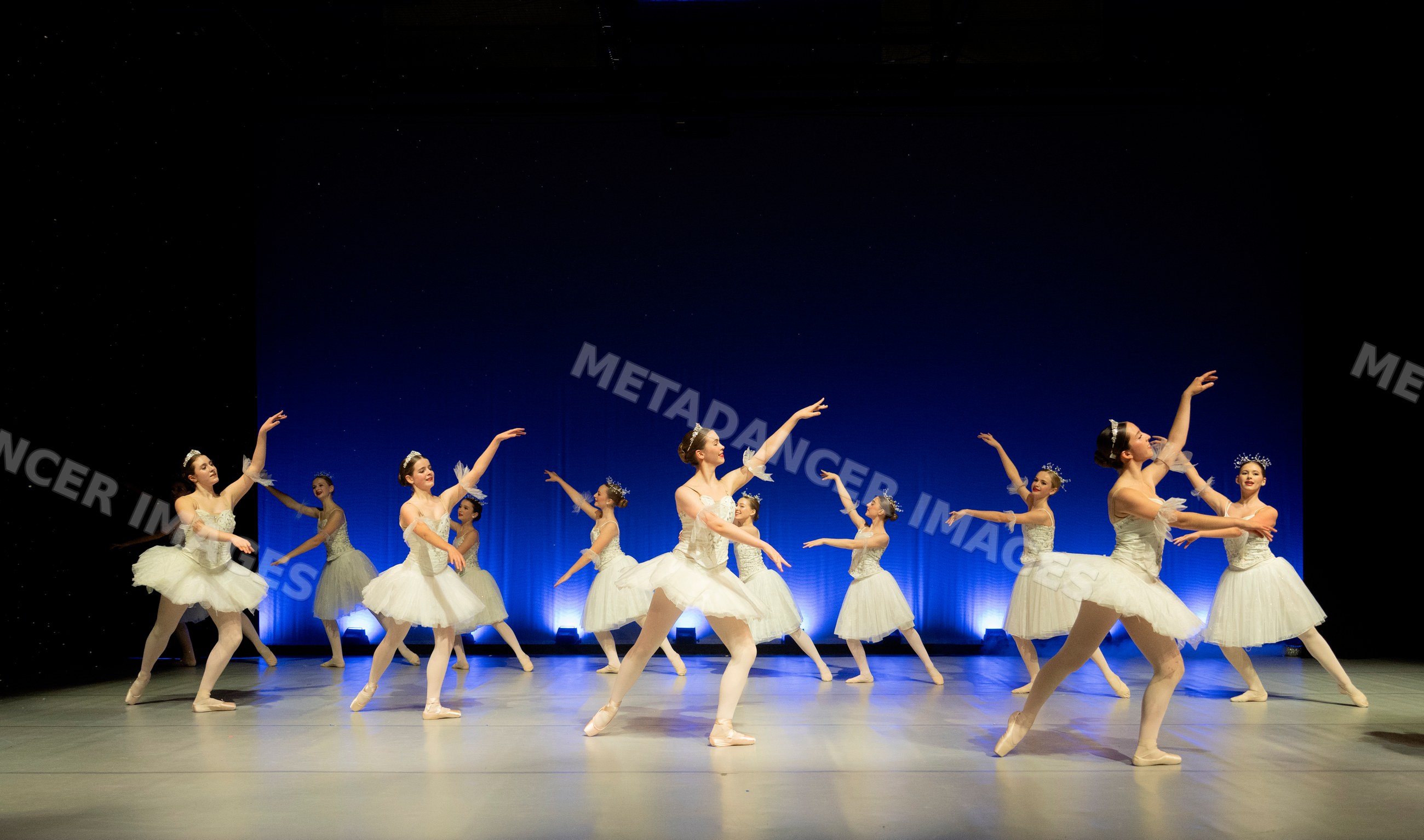 Ballet dancers performing a graceful group dance on stage